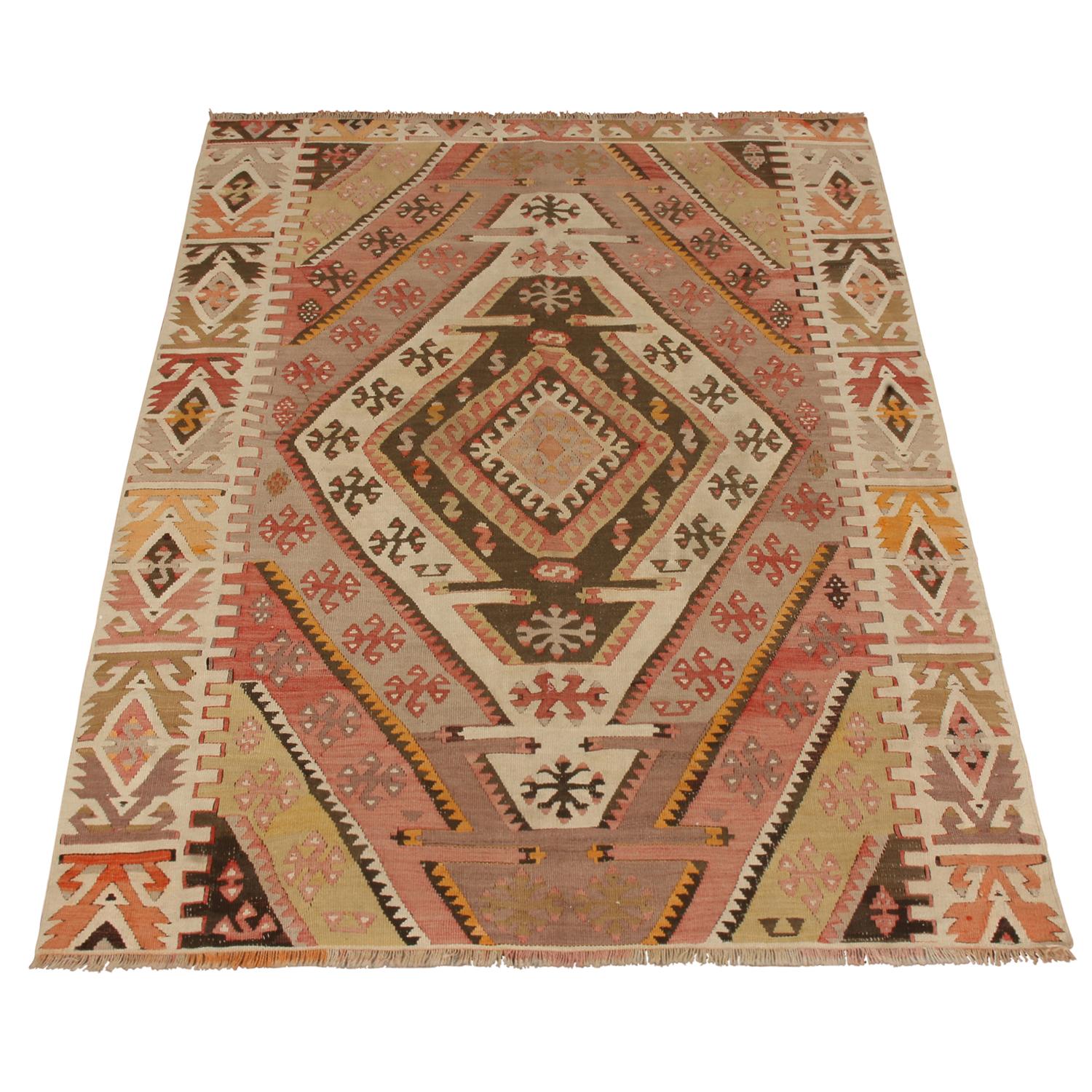 Flat-woven in high-quality wool originating from Turkey between 1940-1950, this vintage Emirdag Kilim rug stands apart from similarly ornate pieces of its family and era for the mixed-symmetry field design, departing from a traditional sense of