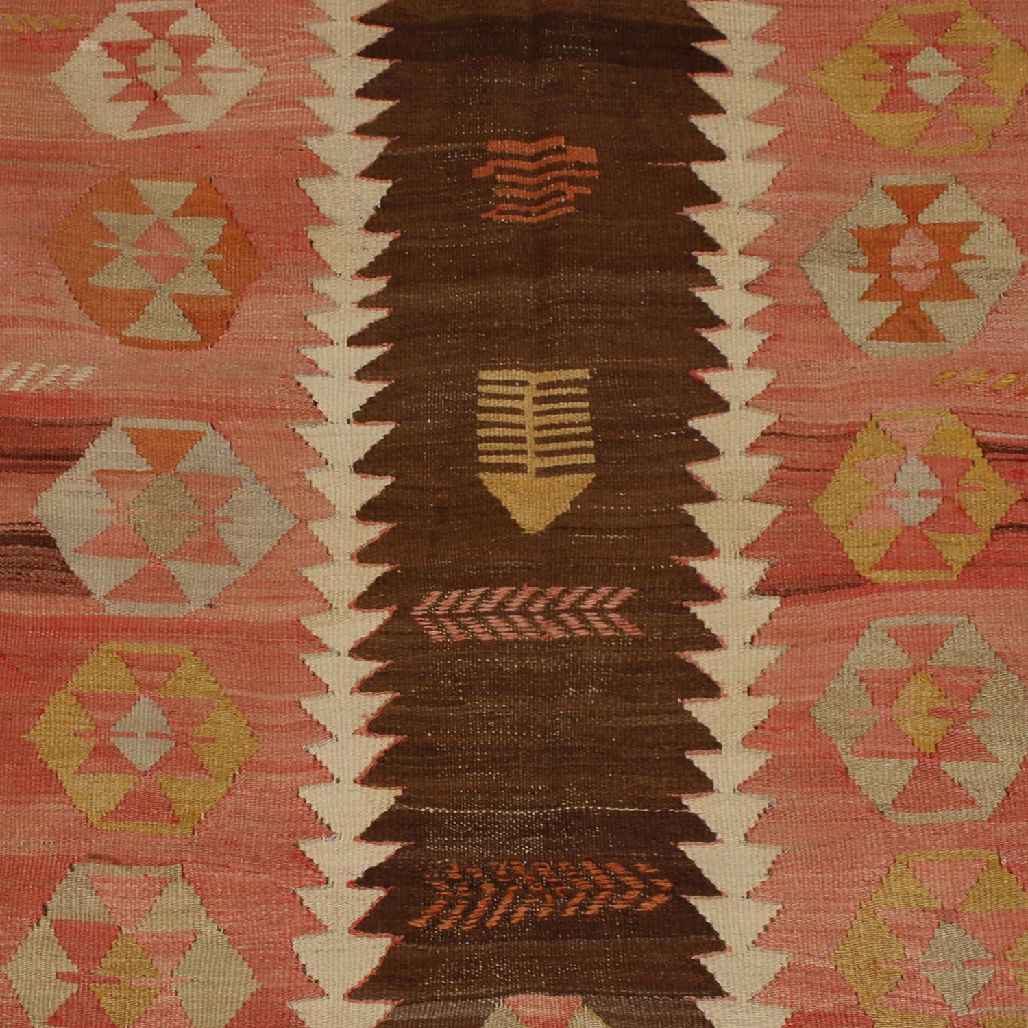 Flat-woven in high-quality wool originating from Turkey between 1930-1940, this vintage Konya Kilim rug enjoys its own individualistic approach to balancing earth tones and brighter colorways, sporting an uncommonly graphed field design with a