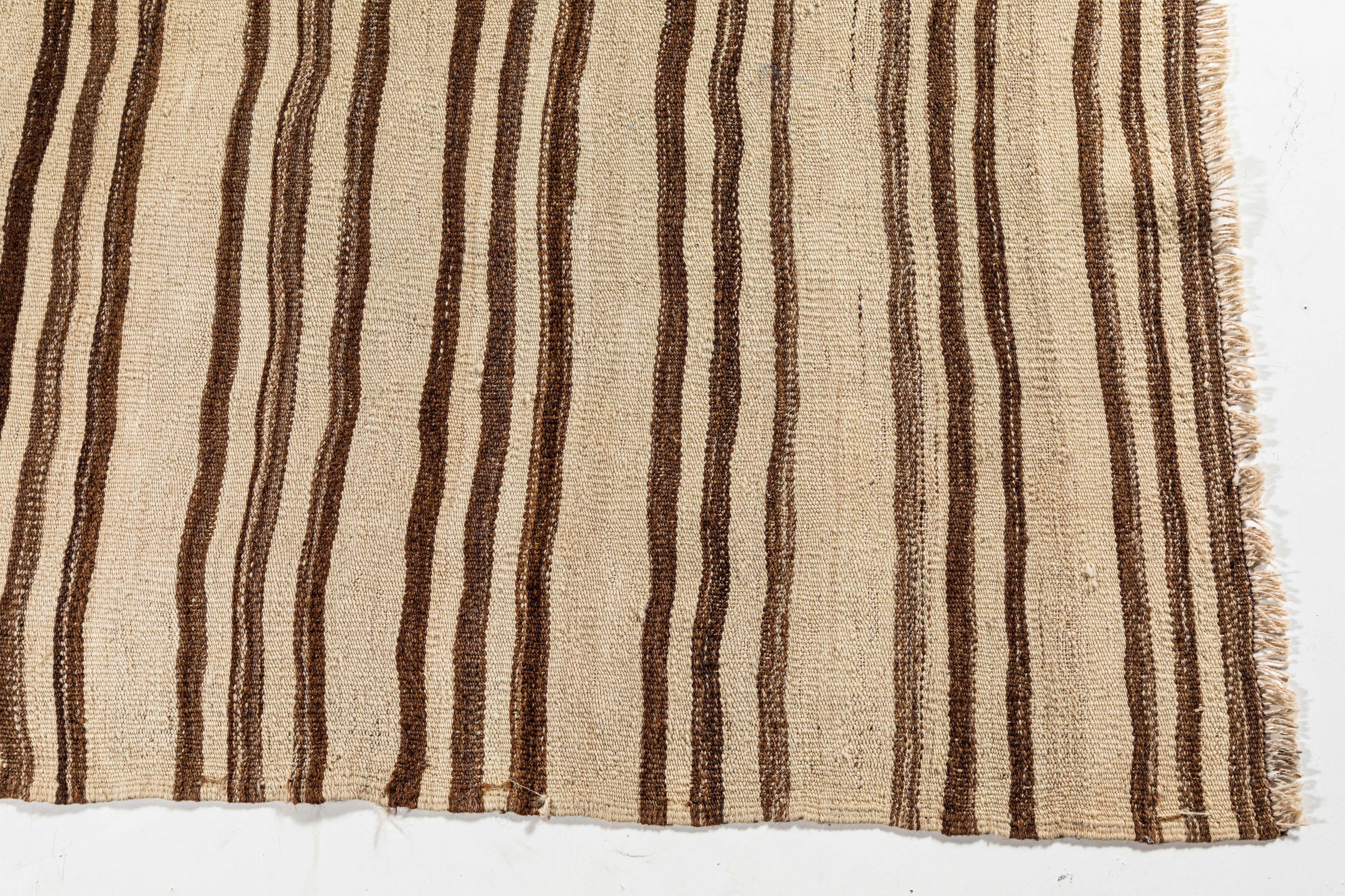 Vintage Konyan flat-weave rug with brown and natural stripes.