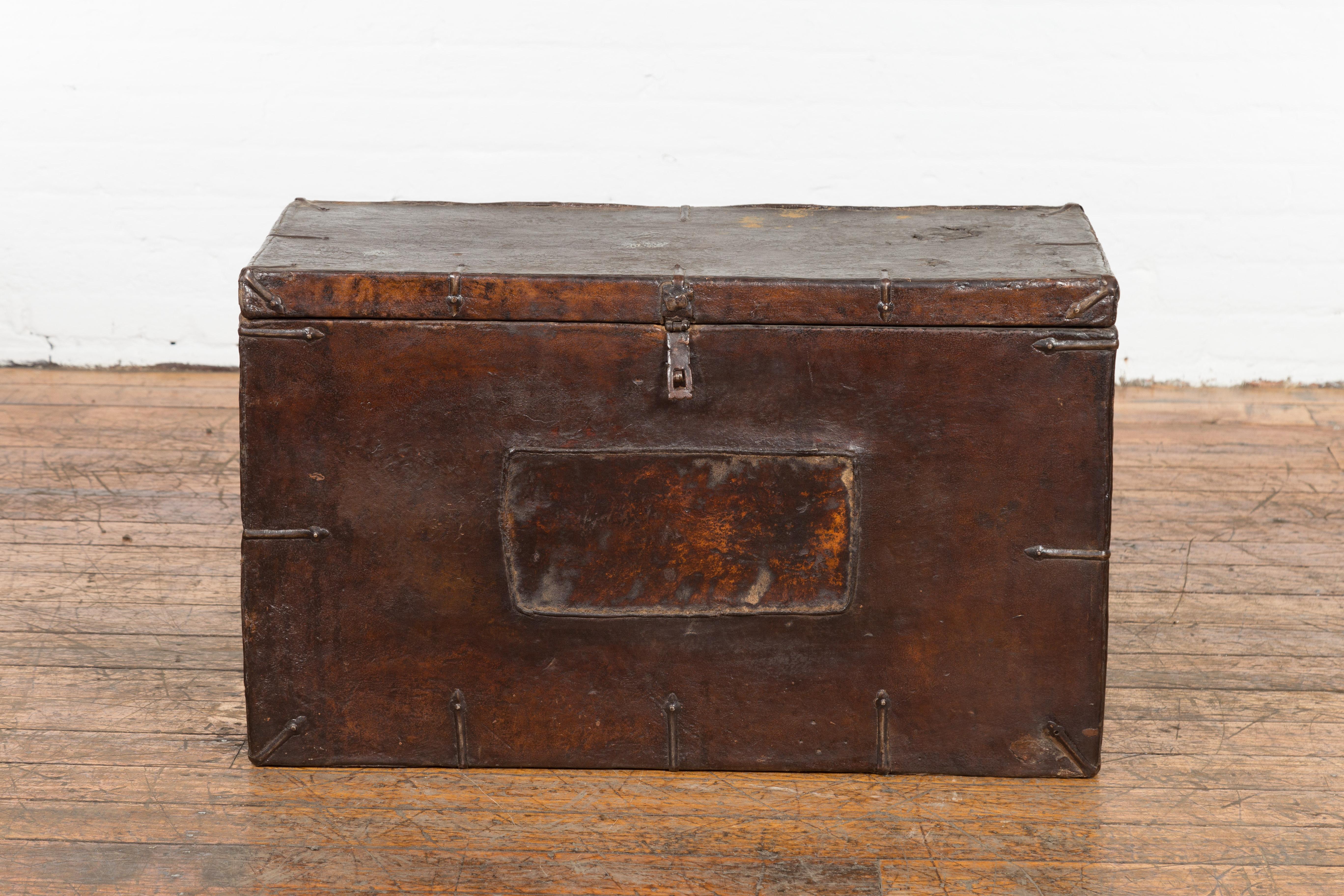 A vintage Korean dark brown leather blanket chest from the mid 20th century with iron hardware and distressed appearance. Created in Korea during the mid 20th century period, this leather blanket chest or trunk attracts our attention with its great