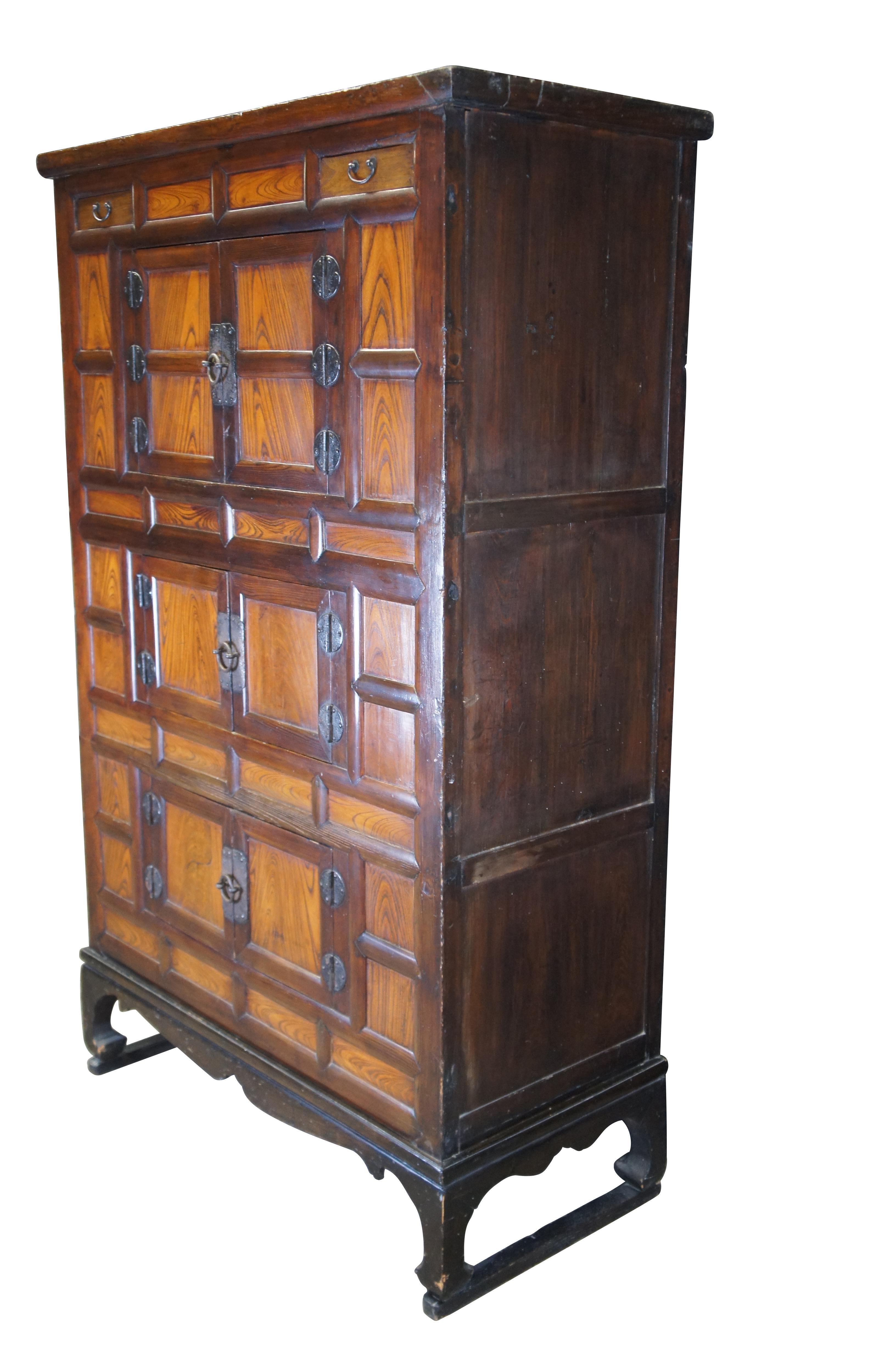 20th Century Korean Tansu Nong Bandaji tallboy wedding chests / cabinet / armoire made of elmwood featuring a two tone wood grain and brass hardware.

Korean Bandaji chest or trunk featuring elm frame with brass hardware. The Korean name bandaji
