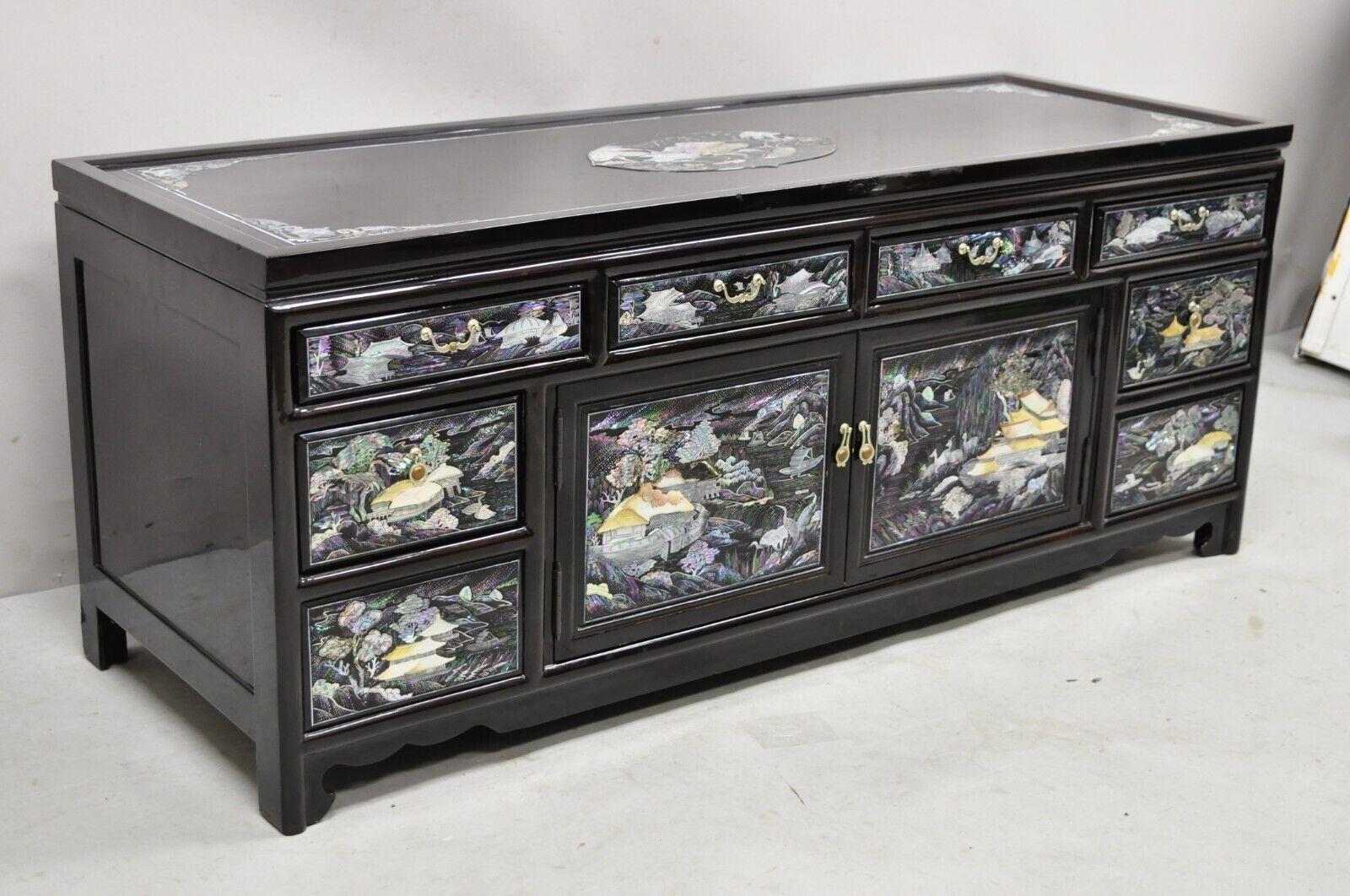 Vintage Korean figural mother of pearl inlay black lacquer low cabinet. Item features stunning figural mother of pearl inlay throughout, black lacquer finish, 2 swing drawers, 6 drawers, great style and form, nice low cabinet. Circa late 20th