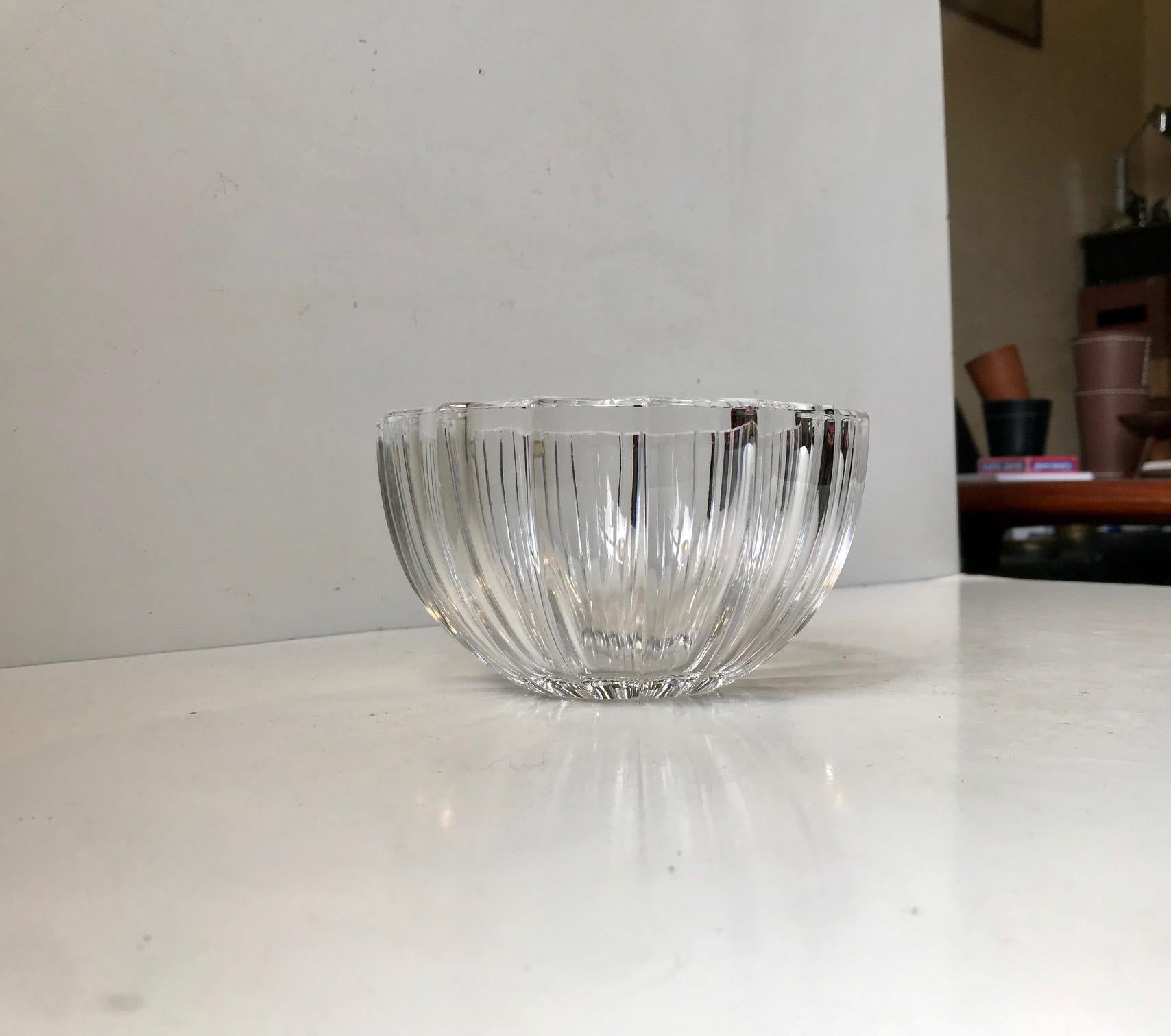 Based upon an Art Deco design from the 1940s this full lead clear crystal bowl from Kosta Boda in Sweden tics all the right boxes when it comes to Art Deco styling. The particular example was made circa 1970. The bowl retains its original sticker