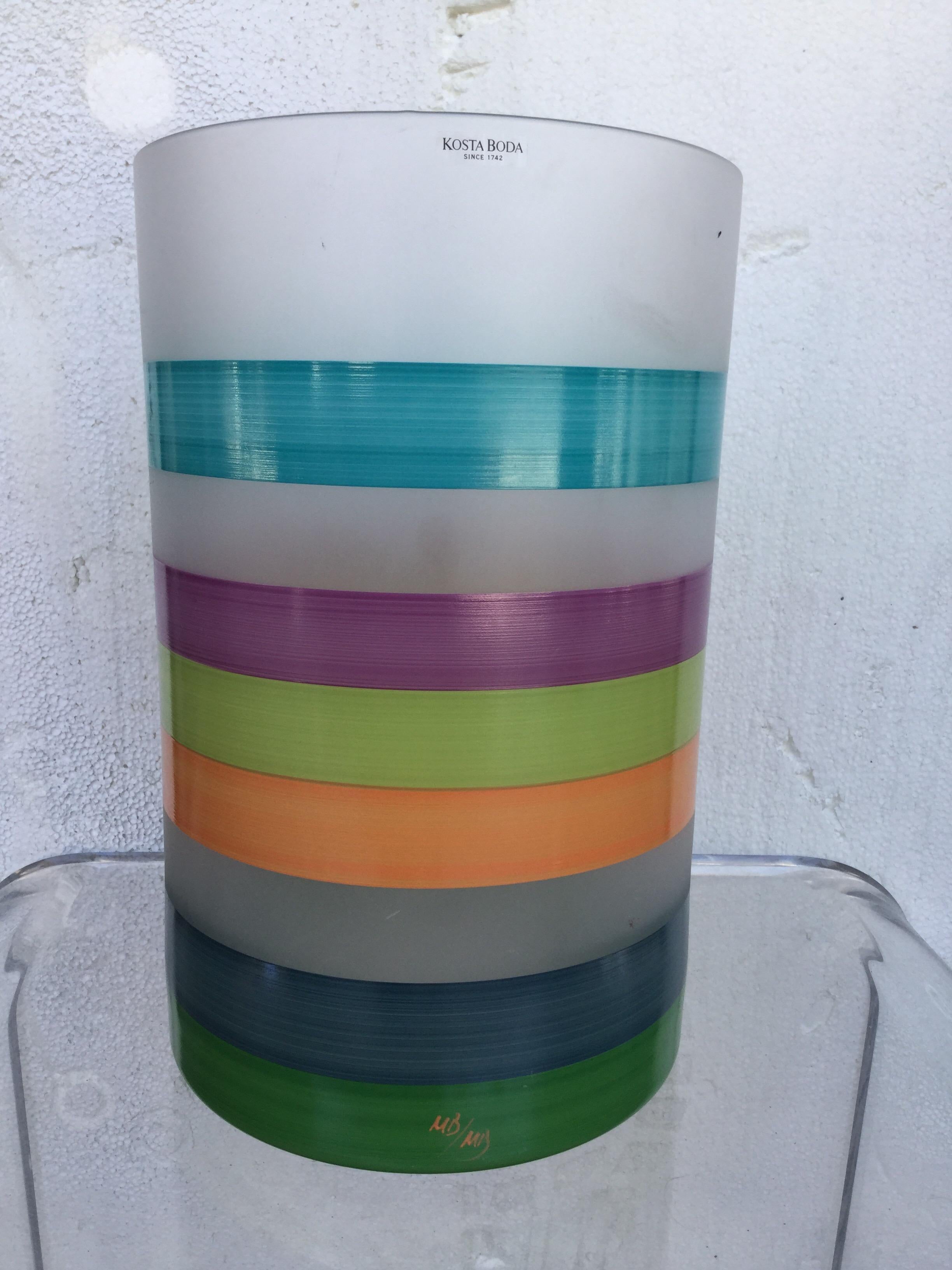 Swedish Kosta Boda glass vase, circa 1970. This vase, designed by Monika Blackstrom, retains its original label as well as the designer's hand painted initials as the multi coloured horizontal stripes have been applied by hand. Please enlarge the