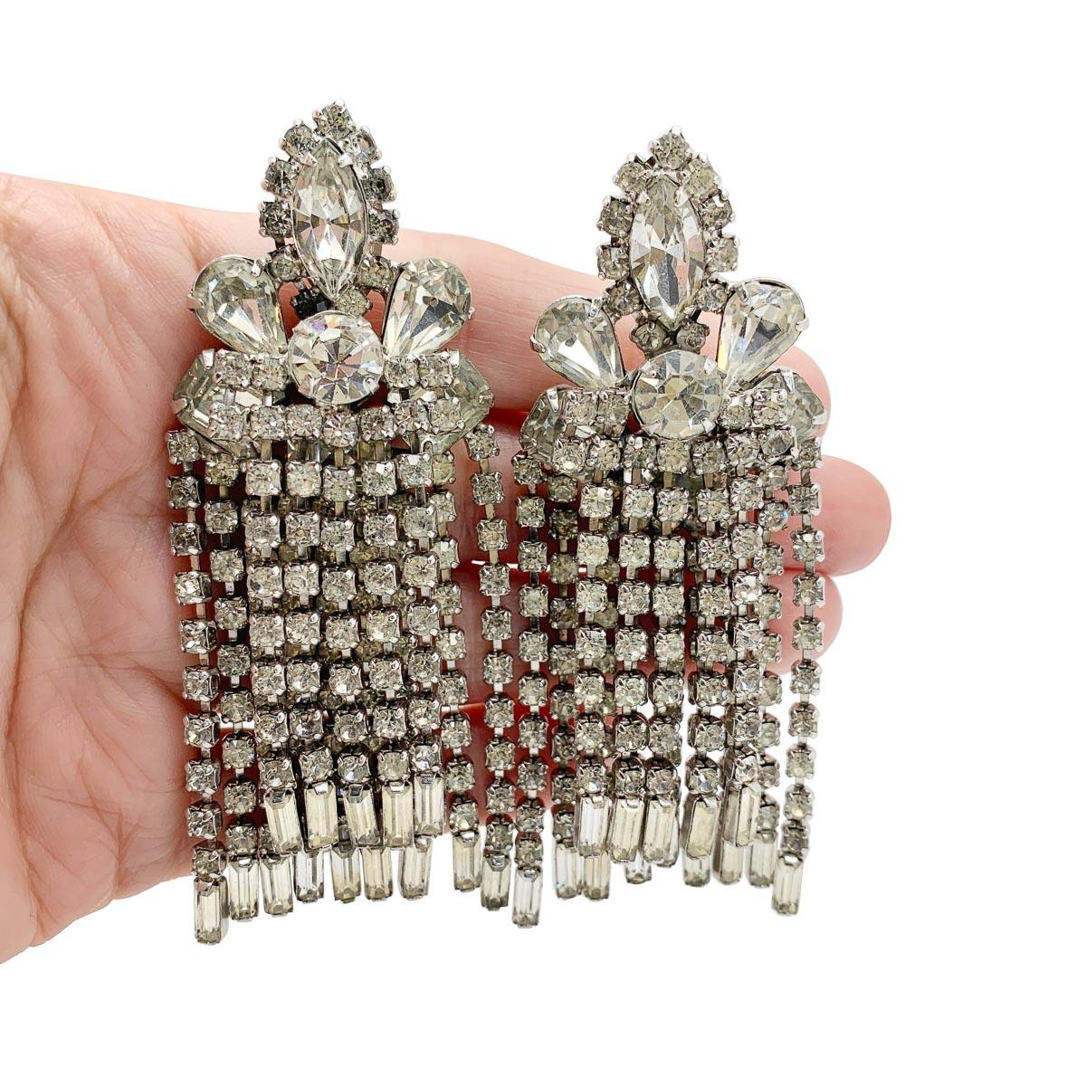 A spectacular pair of Vintage Kramer Chandelier Earrings from the 1950s. Featuring oodles of gorgeous fancy cut stones including pear, marquise, chatons and emeralds cuts. A double layer of tassels finished in baguette cut stones drops away from the
