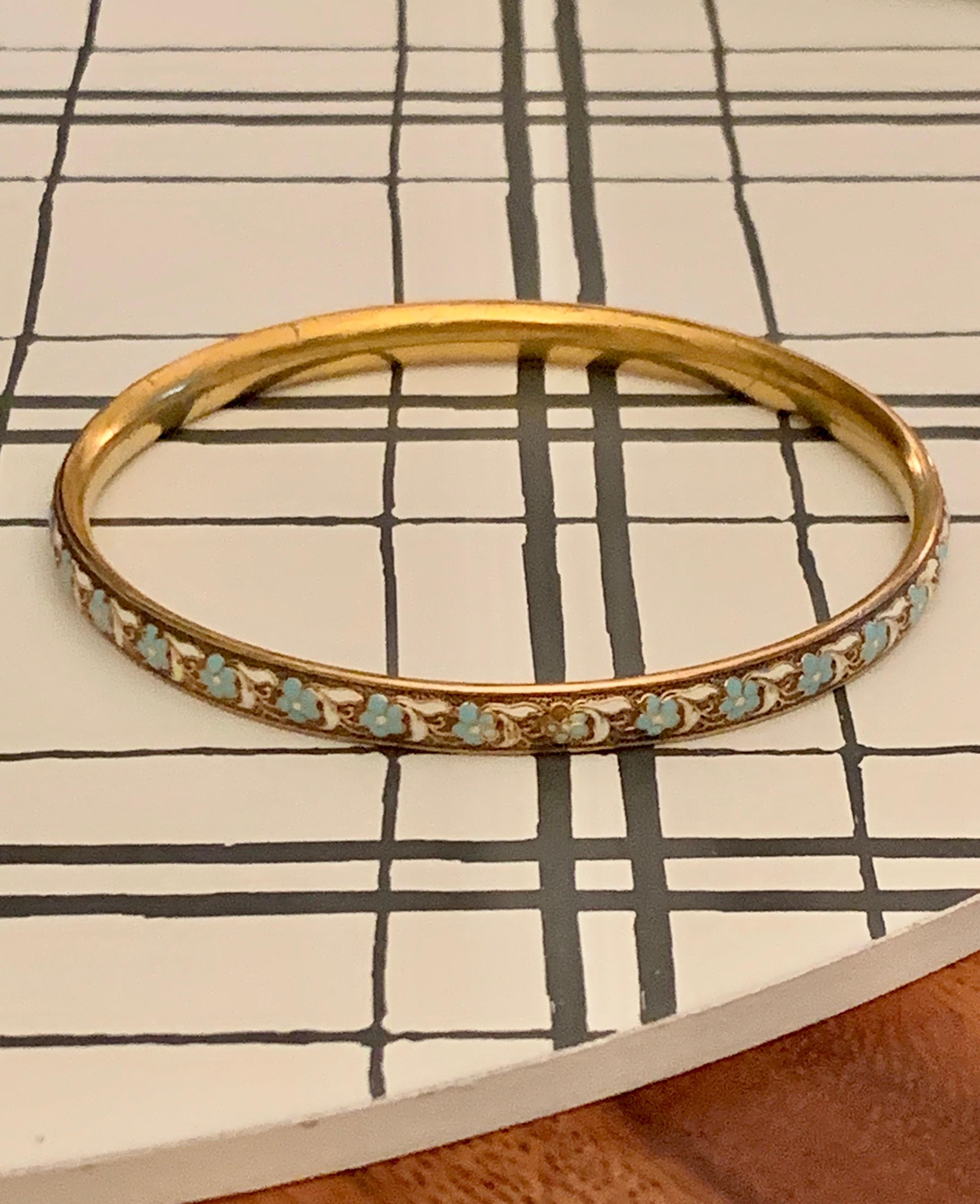This piece is absolutely lovely and could be worn alone, or in combination with so many other bangles or bracelets.  This is a vintage Krementz signed 14 karat yellow Gold bangle.  The enameled floral design is a beautiful color of blue with white