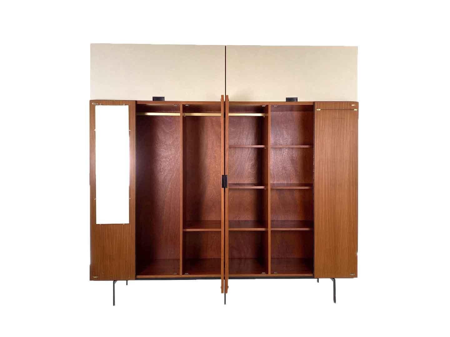 very particularly iconic vintage ku17 wardrobe by cees braakman, produced by pastoe in 1958. the wardrobe belongs to the 'japan series' by pastoe and is a real dutch design classic. the wardrobe has 6 doors with two (three optional) hanging rooms