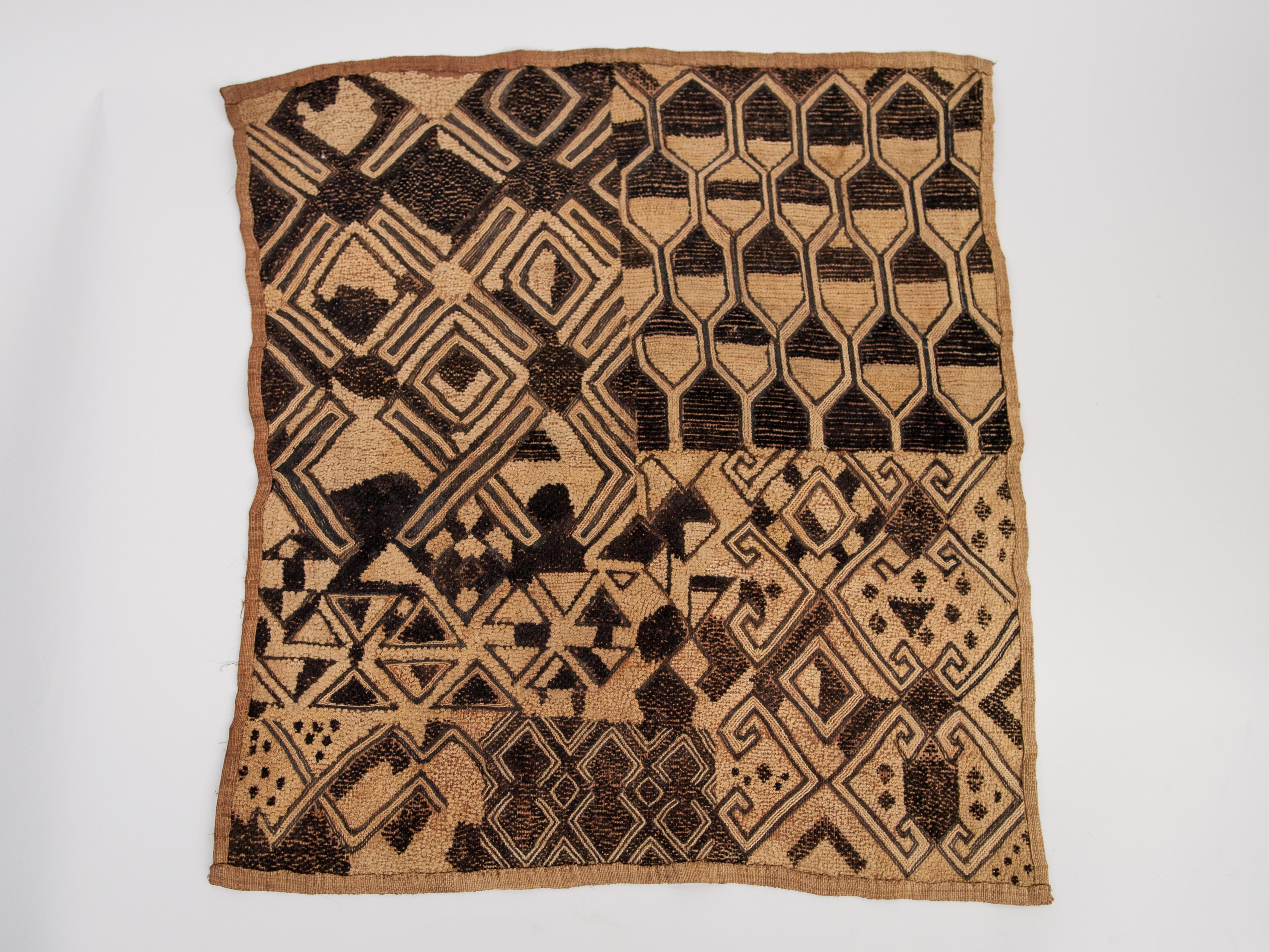 Vintage Kuba textile panel. Handwoven and hand embroidered raffia palm fibre. From the Kuba people of the Democratic Republic of the Congo (formerly Zaire), mid-20th century.
Offered by Bruce Hughes.
Panels like this were worn by women on