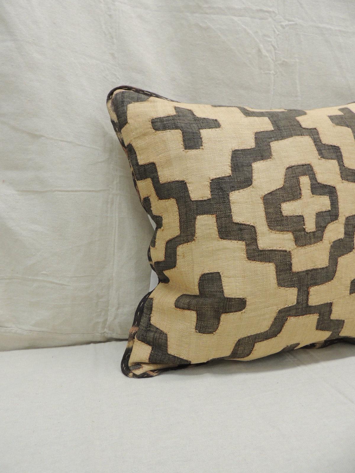 Vintage KUBA tan and black handwoven patchwork African decorative pillow.
Handwoven patchwork and appliqué raffia African decorative lumbar pillow with labyrinth pattern.
We used the original textile frame as a trim all around the pillow. Light