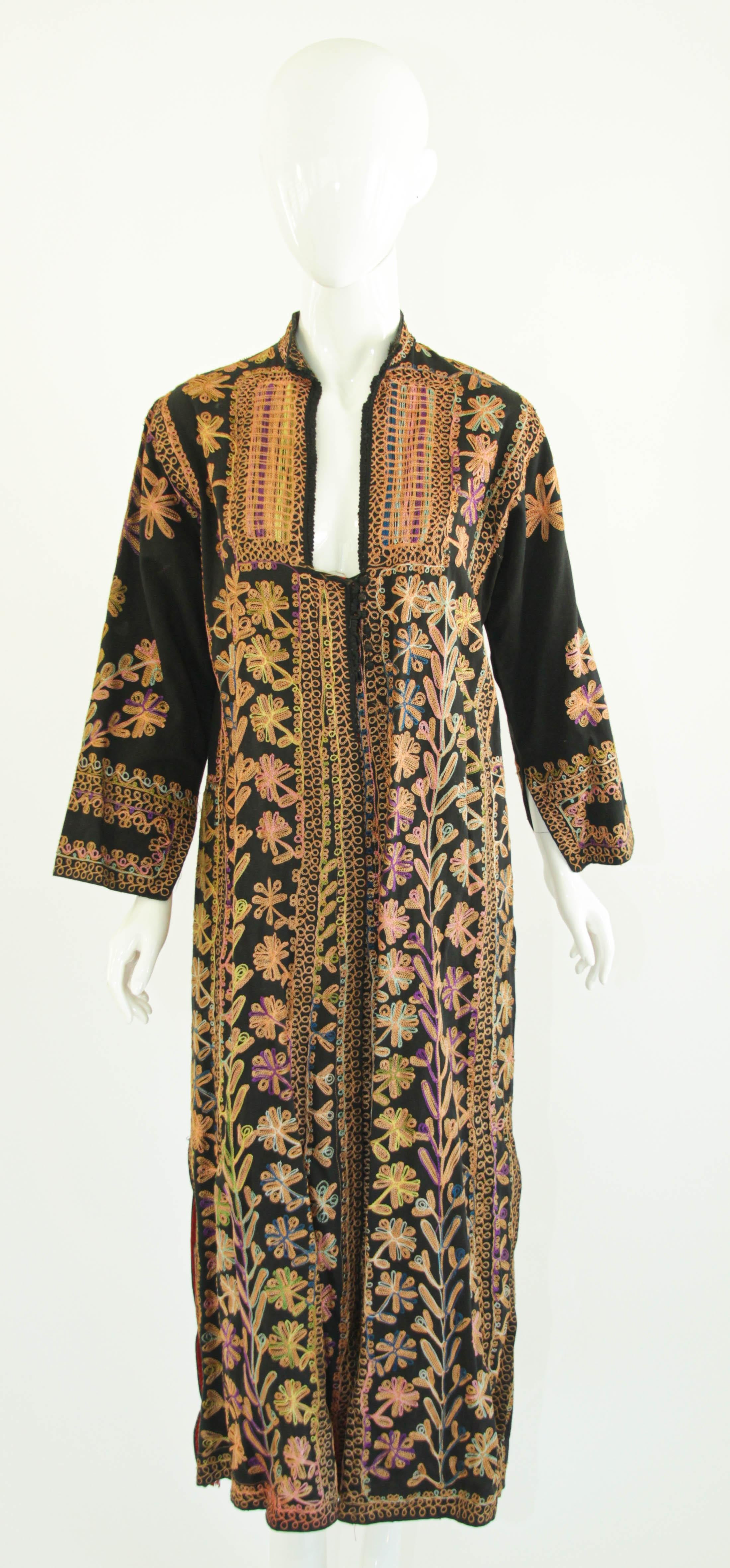 Vintage kuchi dress from Afghanistan, Ethnic Boho Baluchi ethnic dress, embroidered dress circa 1970s.
Vintage embroidered Afghan Kuchi kaftan dress coat. 
Floral patterned cotton with embroidery covering.
Stunning intricate Afghan Kuchi tribe