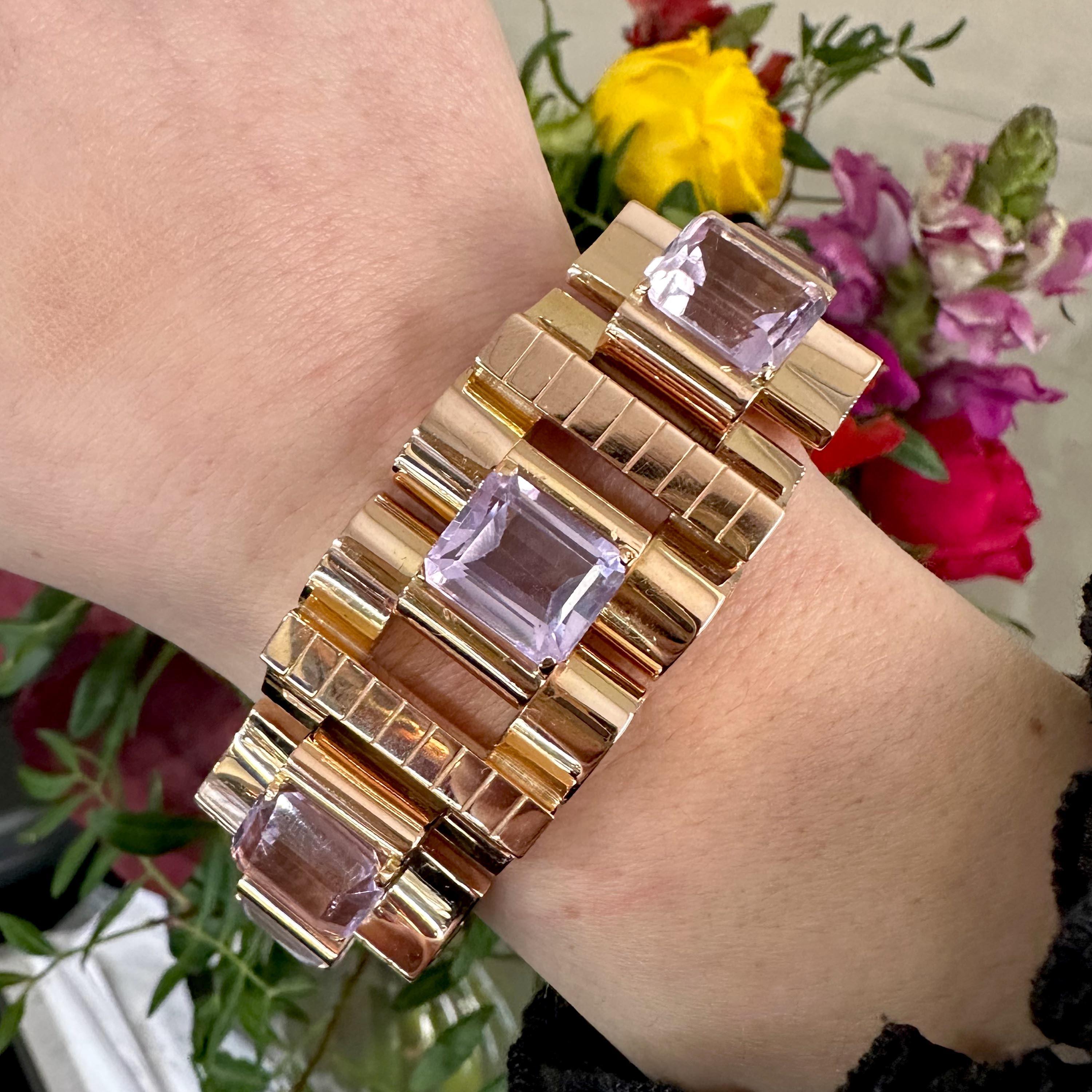 A vintage kunzite and gold three dimensional tank bracelet, set with seven, emerald-cut kunzites, in four claw cupped tank settings, in alternating domed and concave, hinged tank links, with rectangular bars between the kunzites, decorated with