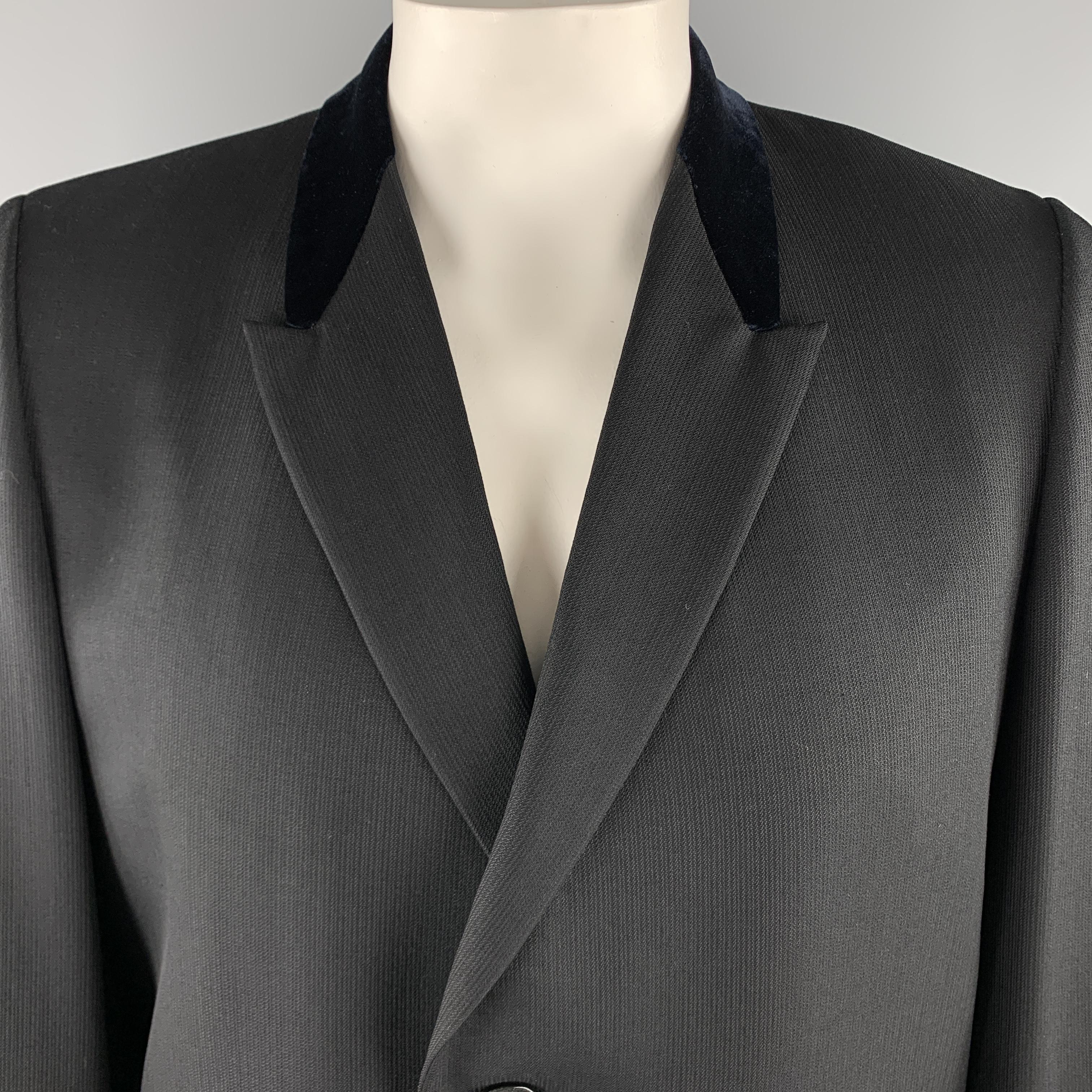 Vintage KUPPENHEIMER long coat comes in a solid black wool material, featuring a navy velvet peak lapel, two buttons at closure, single breasted, flap pockets, unbuttoned cuffs, and a double vent at back. 

Excellent Pre-Owned Condition.
Marked: US