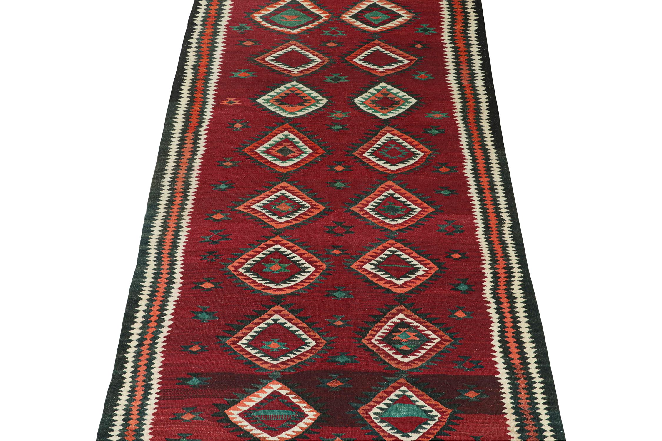 This vintage 5x10 Persian kilim is believed to be a Kurdish tribal rug, handwoven in woo circa 1950-1960. 

Further on the Design:

The design prefers polychromatic medallions on a red open field, wrapped in charcoal, white, and salmon borders. Keen