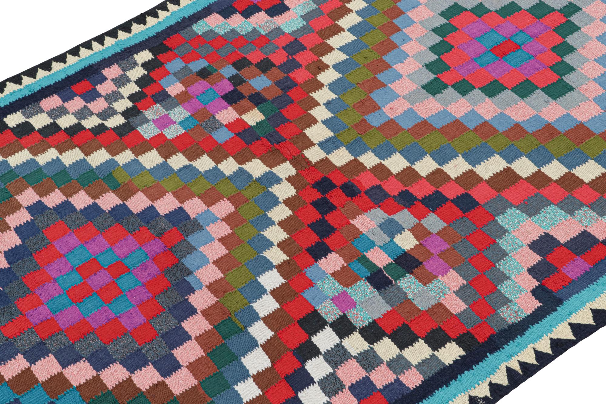 This vintage 5x9 Persian Kilim is handwoven in wool, and is believed to originate from Kurdistan circa 1950-1960.

On the Design: 

The fabulous flatweave enjoys geometric patterns in bright tones favouring red & sky blue. The one of a kind