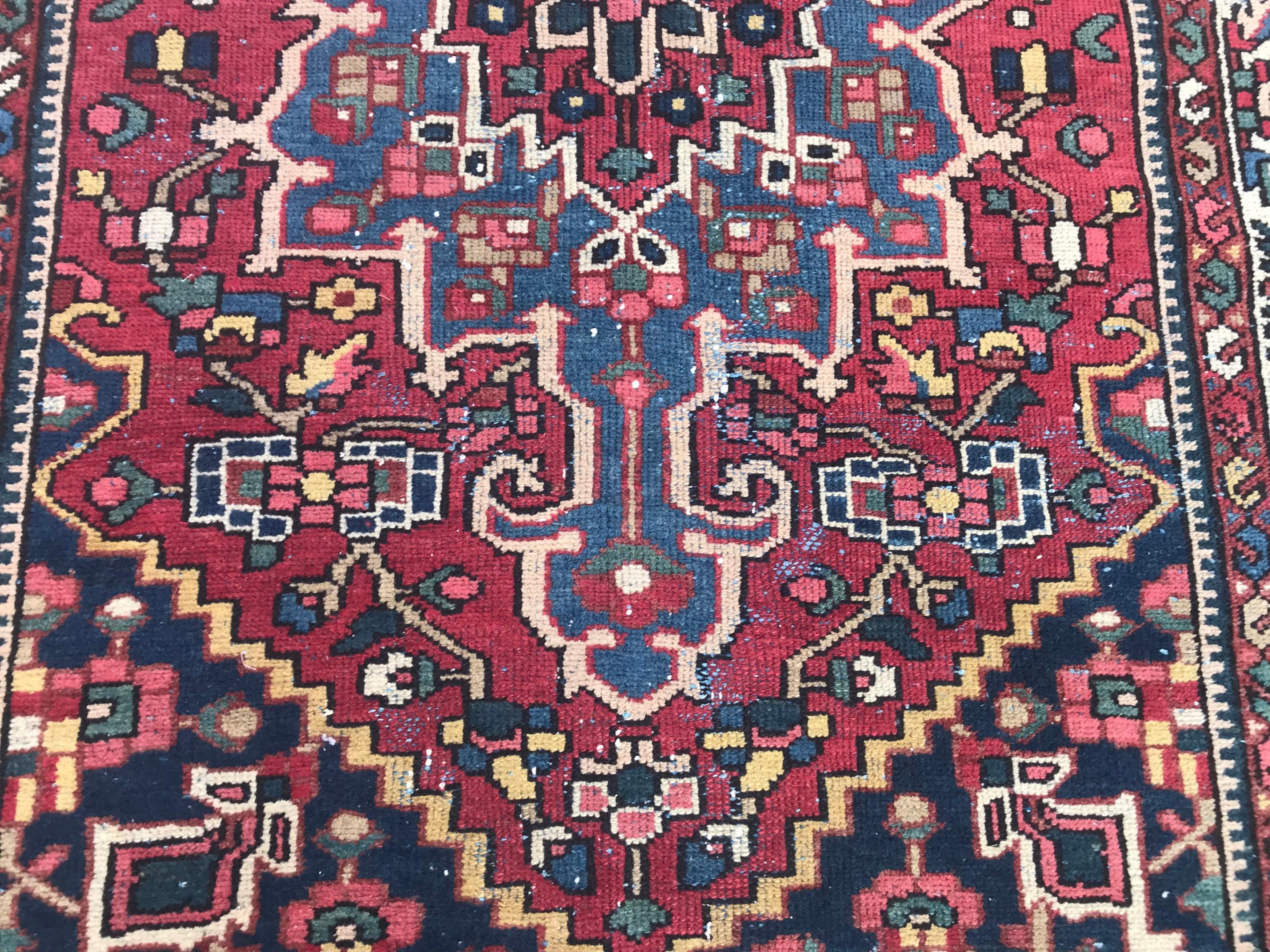 Beautiful mid-20th century rug with tribal design and beautiful colors. Entirely hand knotted with wool velvet on cotton foundation.
