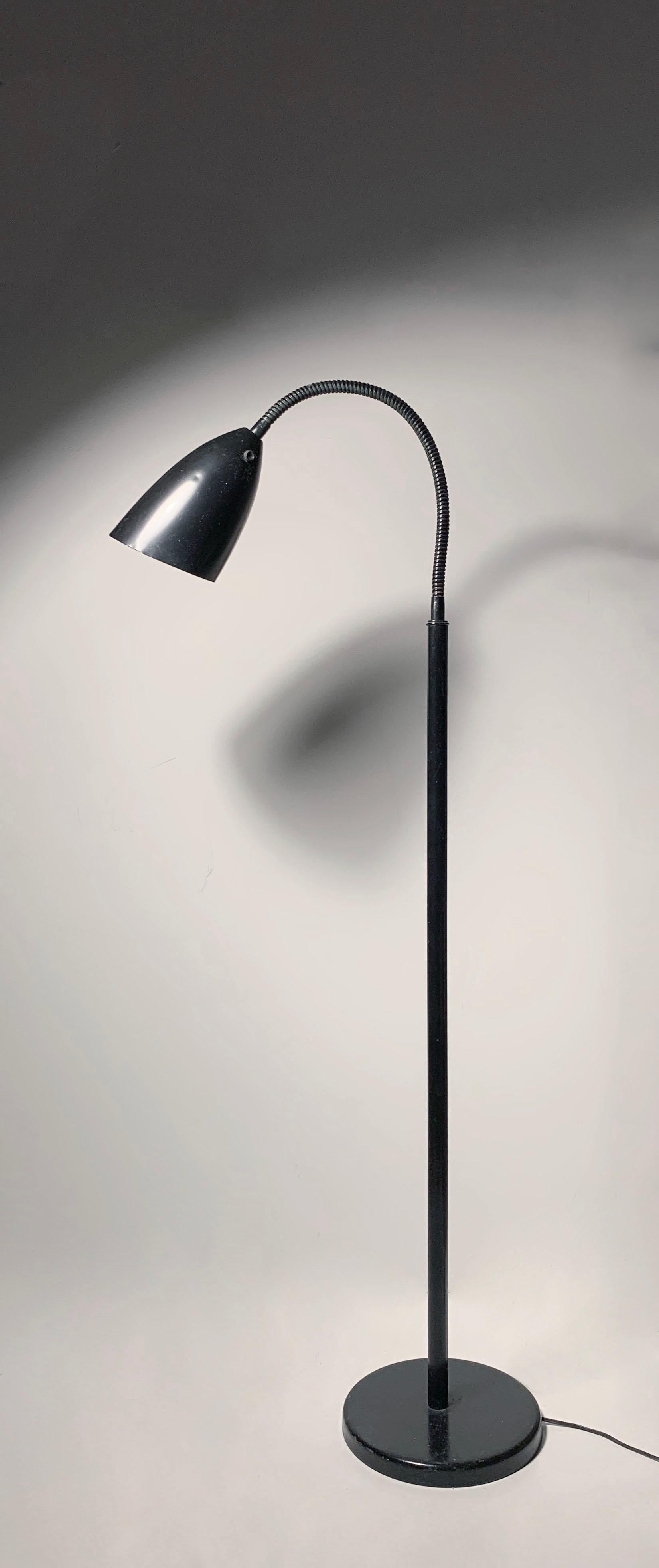 A simple industrial design lamp survivor with a single bullet form shade. Attributed to Kurt Versen.  These are always a bit surreal when perfectly fluid like this one. 

Appears to have been repainted black at one time over the original color.