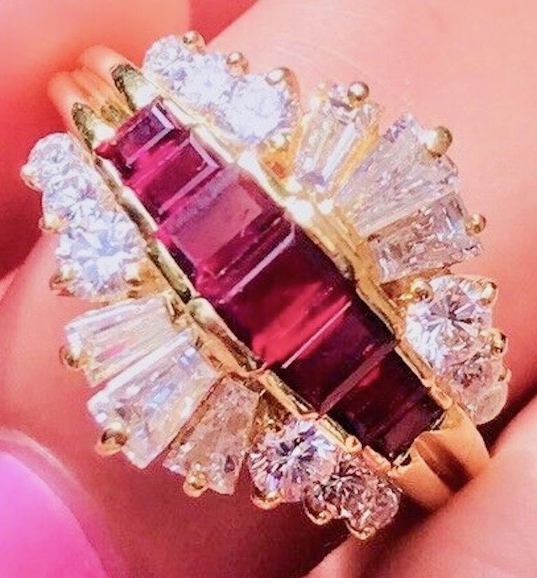 This jaw dropping scintillating diamond and blood red ruby ring features an 18K yellow gold framework in a stunning design of rubies and baguette diamonds. This cocktail ring features 12 white VS brilliant cut round diamonds totaling 0.68 carats, 6