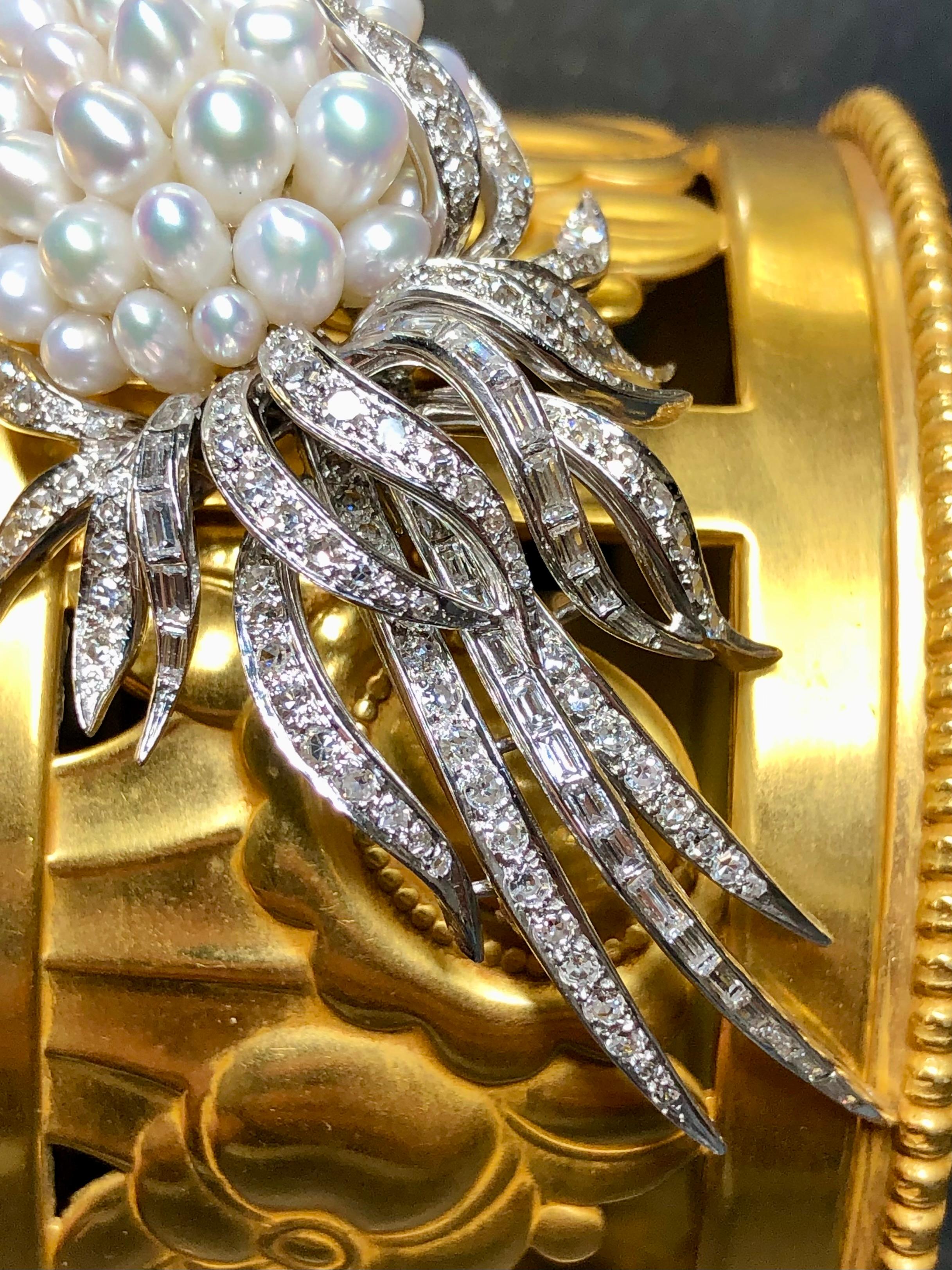 A beautiful vintage brooch c. the 1960’s by famous American designer, Kurt Wayne. Crafted in 14K white gold, the cluster brooch has been set with numerous freshwater pearls as well as approximately 2cttw in H-I color Vs1-2 clarity round and baguette