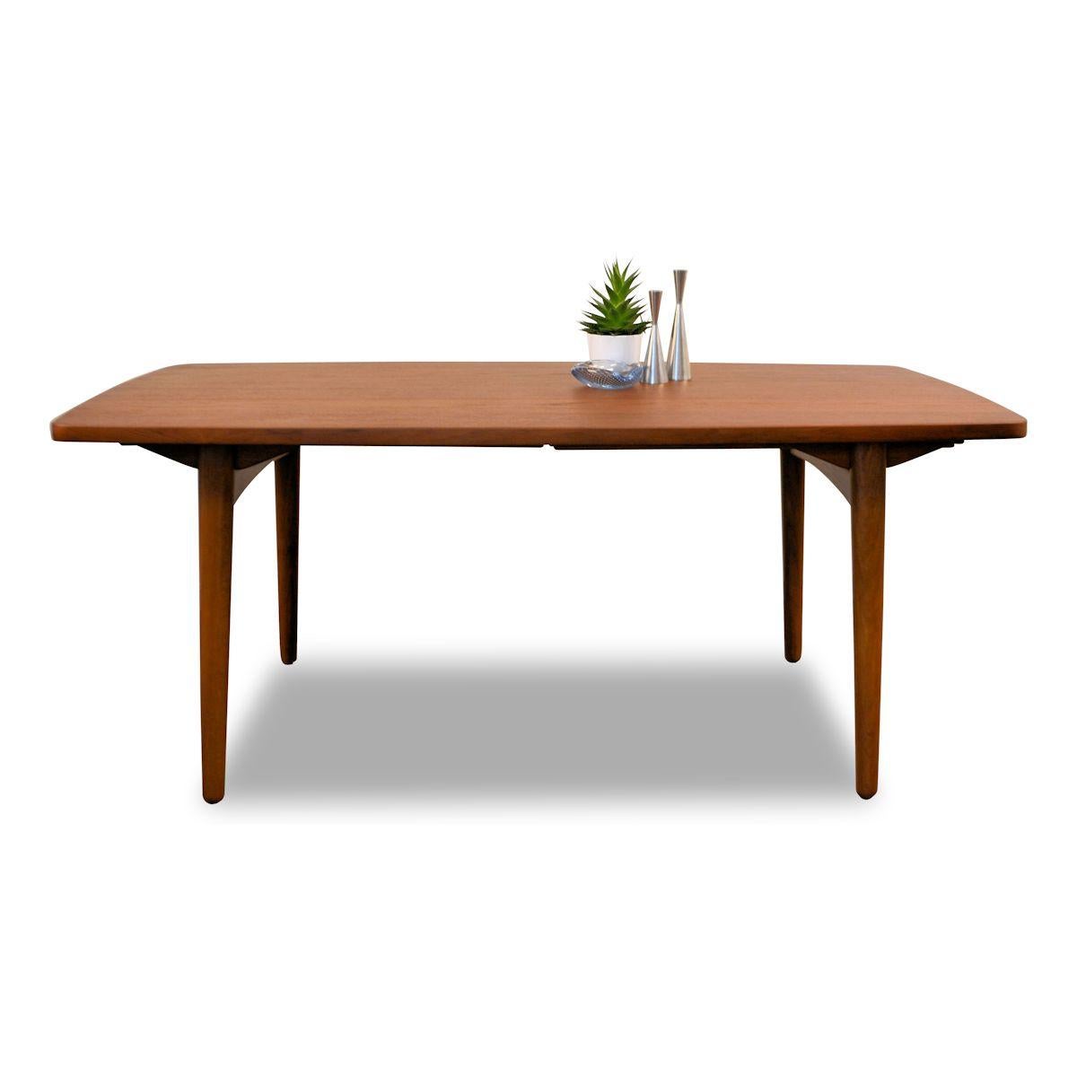 Stylish vintage Danish teak dining table designed by L. Chr. Larsen & Son. This rare table features a thick beautifullly grained teak top on solid but stylish oak legs. You’ll easily host a a party of ten with the two extension pieces, adding 82 cm