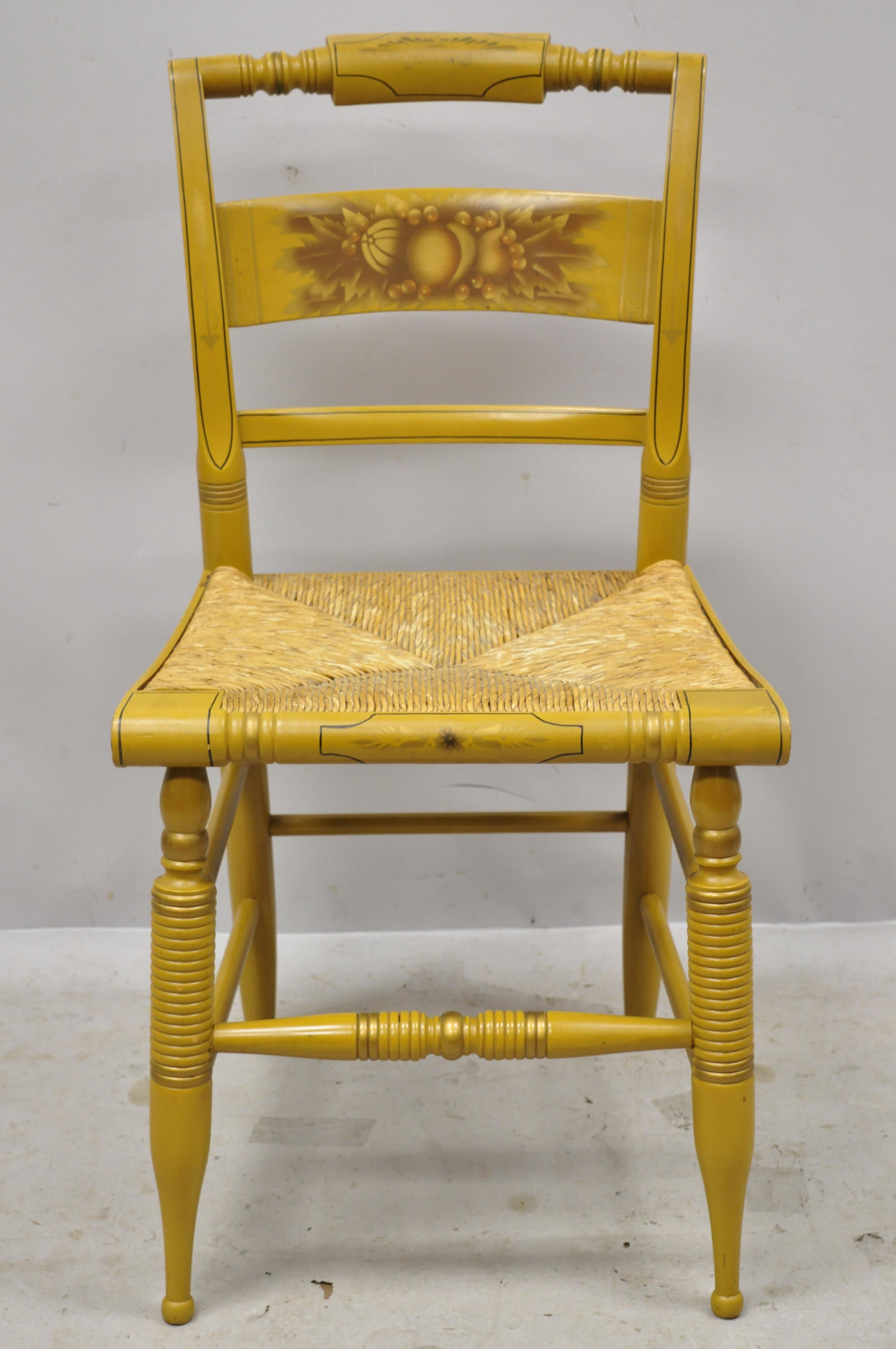 L. Hitchcock yellow stenciled rush seat dining side chair. Item features yellow stencil painted details, woven rush cord seat, solid wood construction, original signature, very nice vintage item, quality American craftsmanship, circa mid-20th