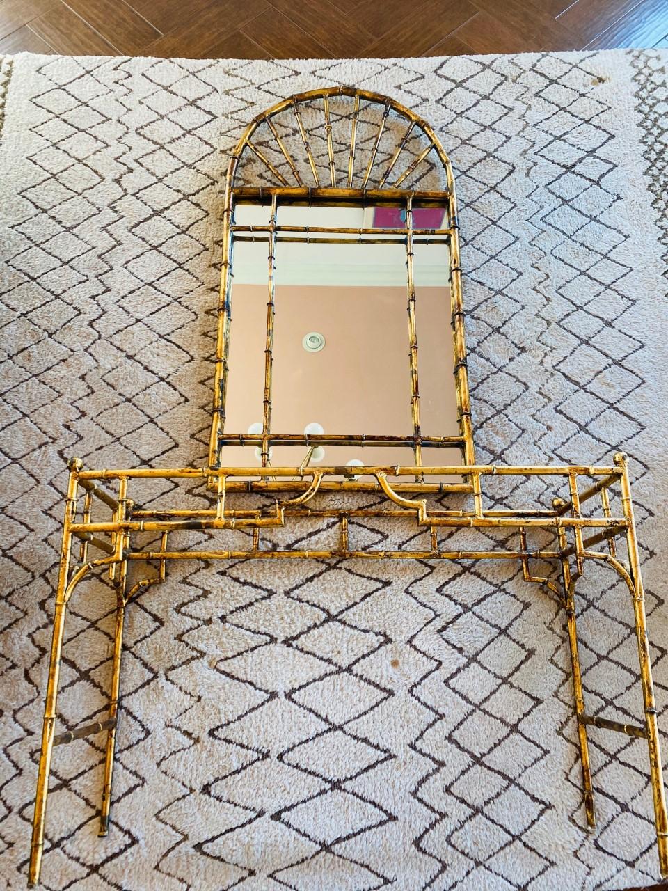 Beautiful vintage set by La Barge that brings the exact amount of glamour and shimmer. The gilded metal mirror and console are fashioned in a sculptural rendering of bamboo that shimmers in gold. This set can complement a variety of decor styles