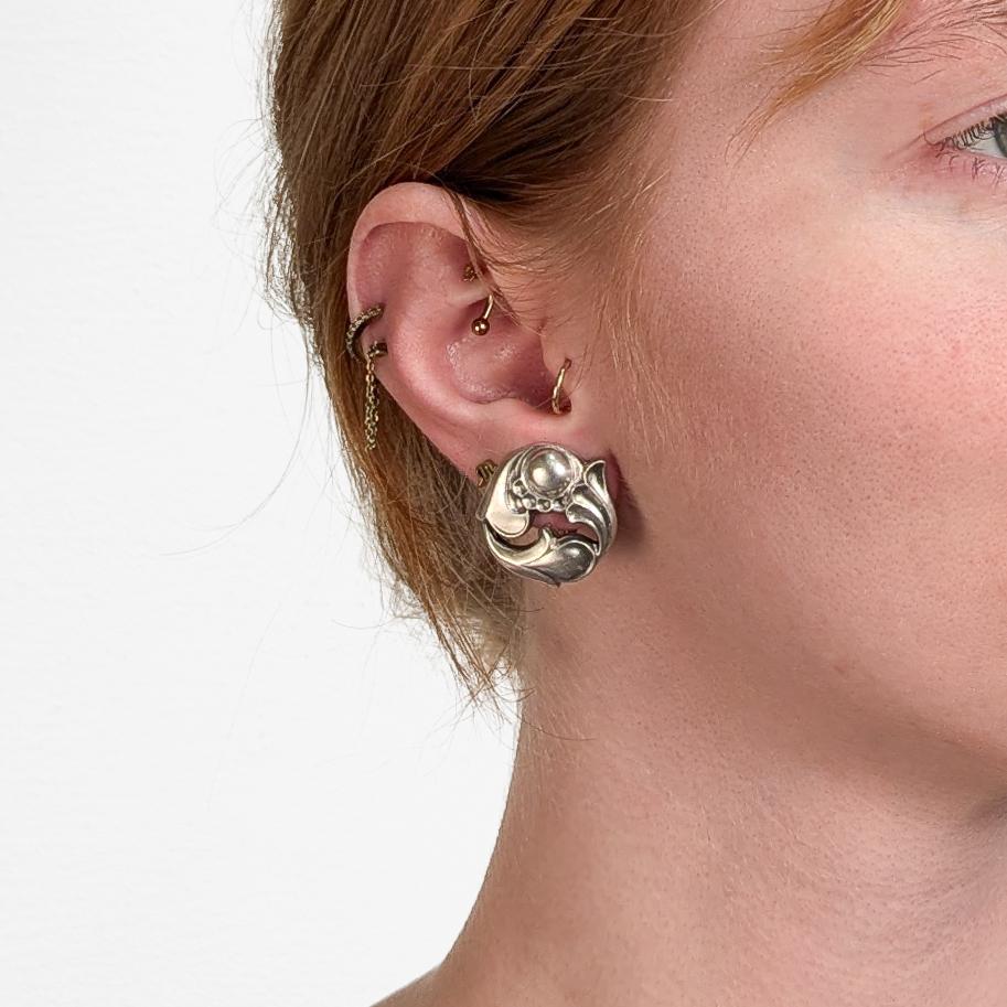 A fine pair of vintage signed silver earrings.

By Alphonse La Paglia for the International Silver Company.

In sterling silver.

Pattern no. 140.

Each with a clip-on closure.

Alphonse LaPaglia (1907 - 1953) was a Sicilian silversmith, who studied