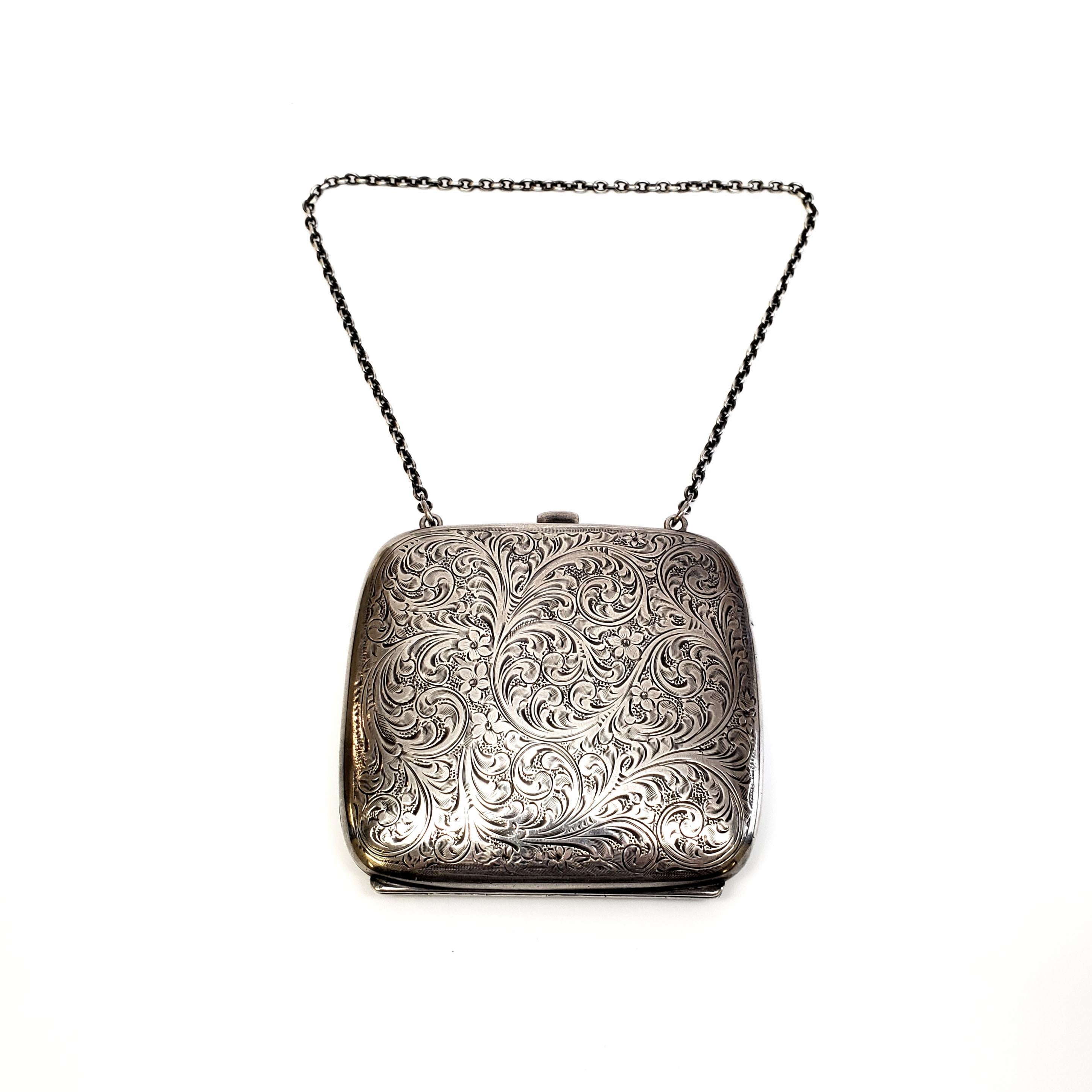 Vintage sterling silver coin purse by La Pierre Manufacturing Co.

Etched floral and flourish engraved design with monogram on one side. Round link chain strap and interior pockets on each side.

Monogram appears to be NBJ

Size: 3 1/2