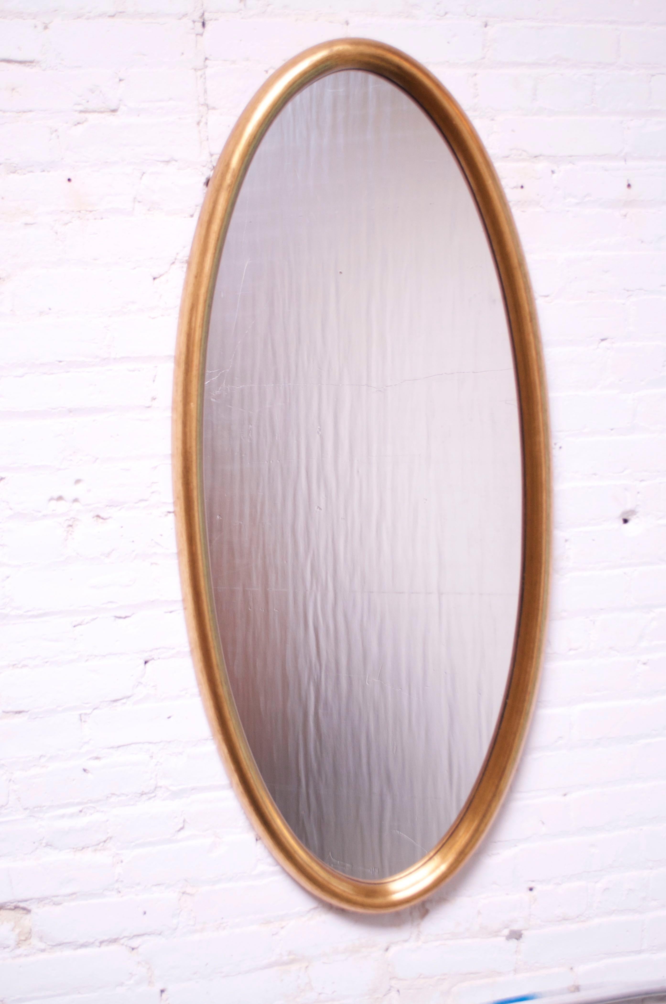 This oval-form Labarge mirror is composed of inset glass within a deep, giltwood frame. Only minor wear to the gilt, and the glass is clean. Overall, excellent, vintage condition.