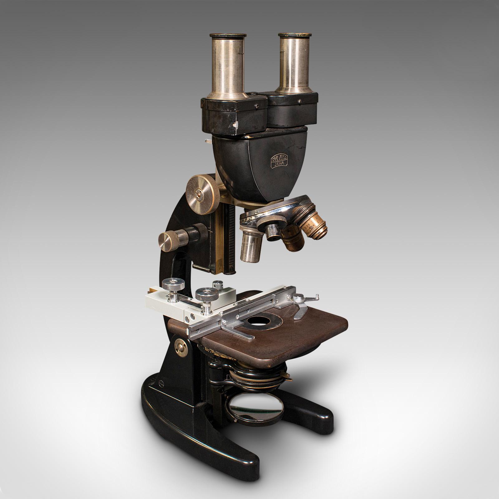 This is a vintage laboratory microscope. A German, enamelled metal scientific instrument by Carl Zeiss Jena, dating to the late 20th century, circa 1970.

Delightfully presented within a robust case with numerous accessories.
Displays a desirable