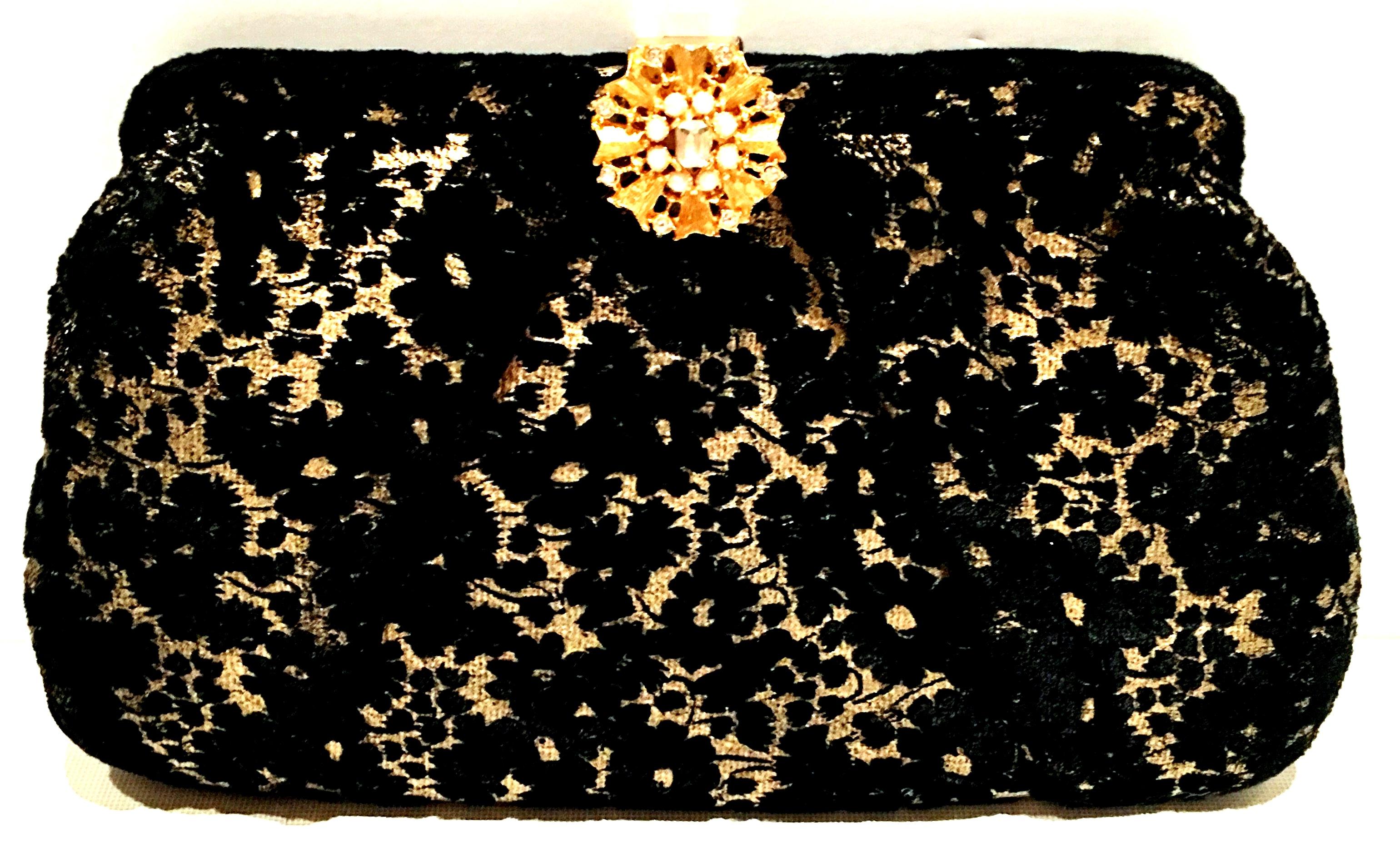 1960'S Beautiful black velvet lace over gold metallic leather evening bag. Features a gold tone with Austrian clear crystals and round faux pearl bead adorned snap closure ornament. Ornament measures, 1.13