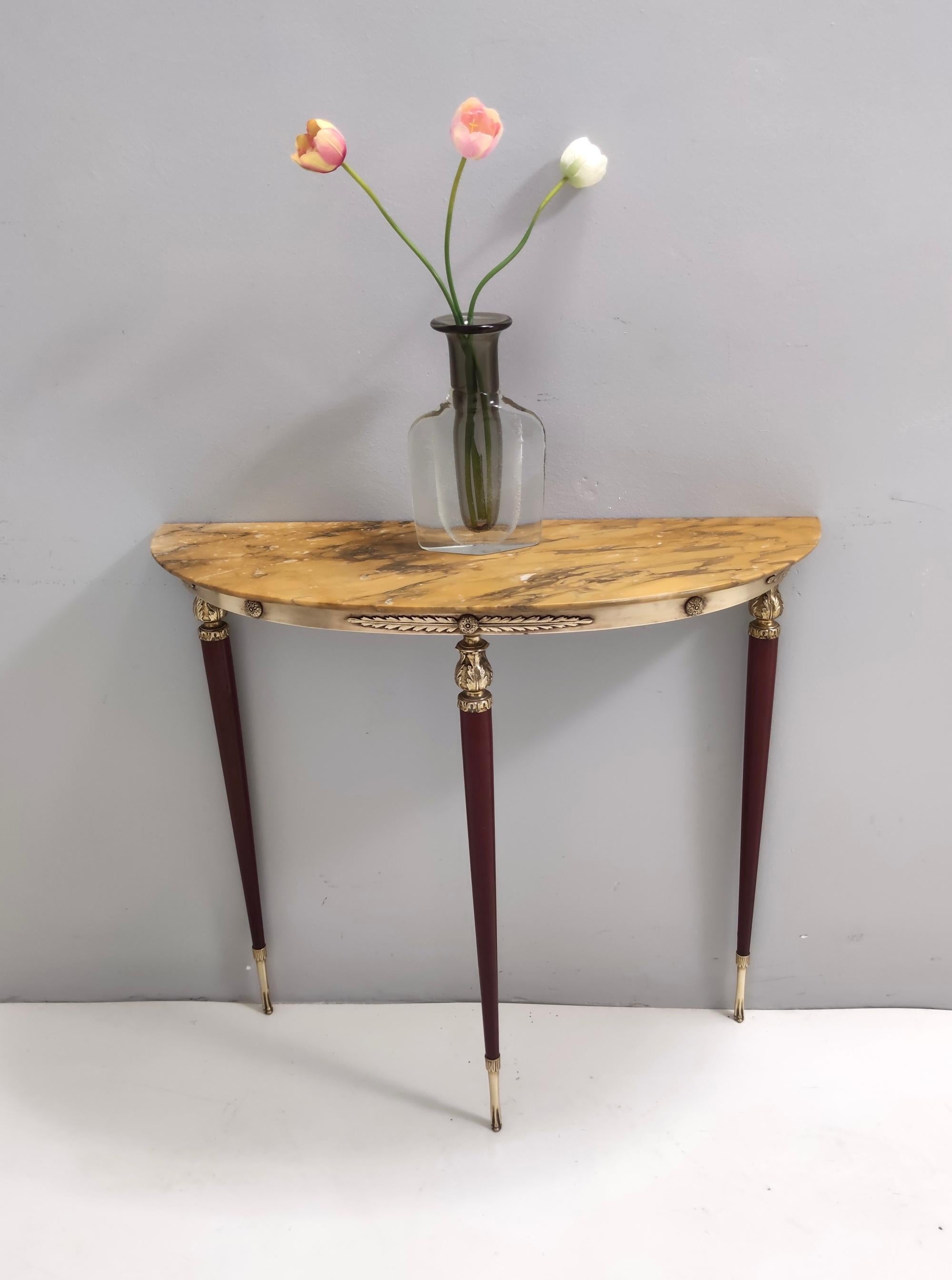 Made in Italy, 1950s. 
This console features a lacquered beech frame, brass details and feet caps and a yellow marble top.
It might show slight traces of use since it's vintage, but it can be considered as in excellent original condition and ready