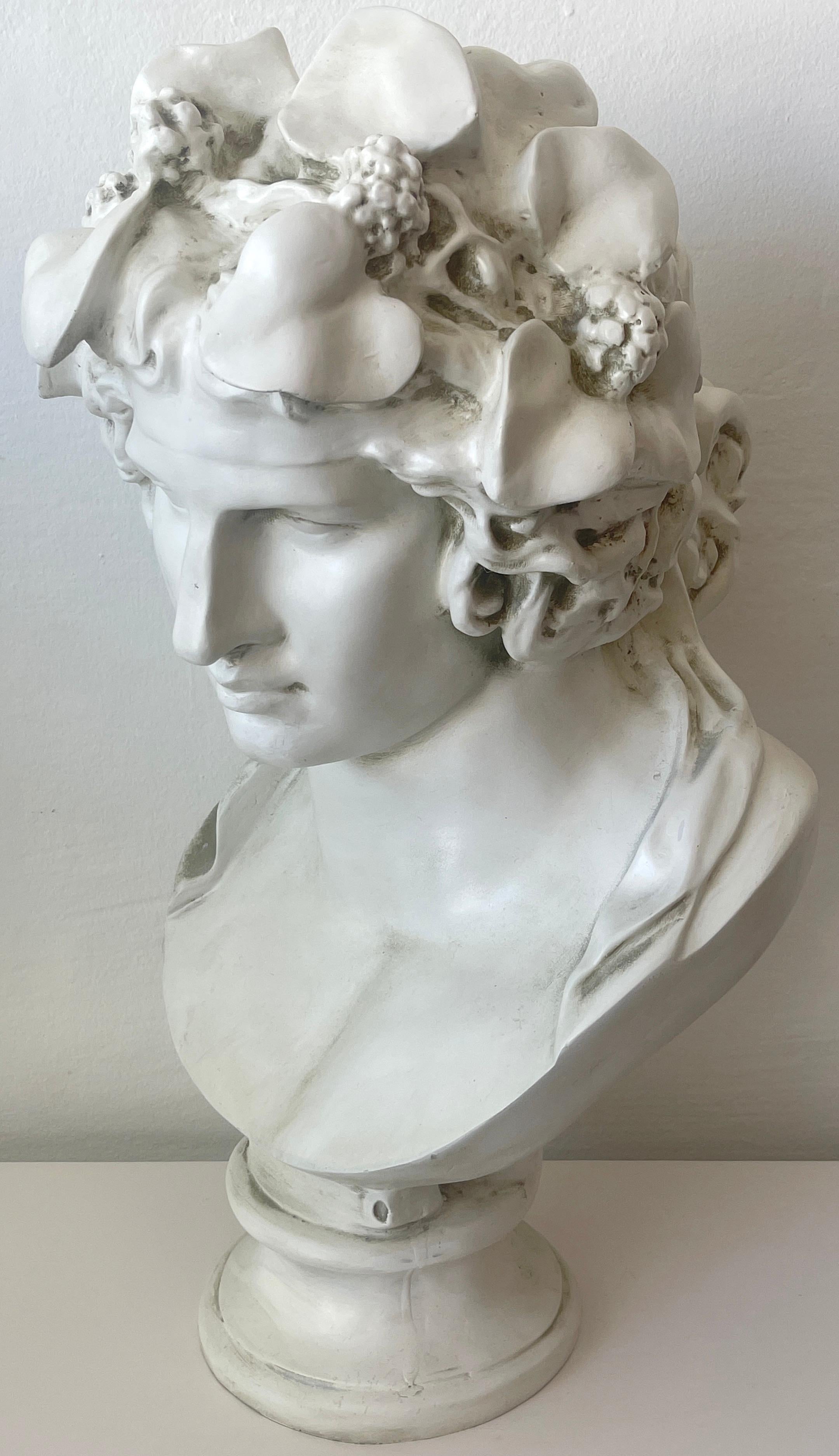 Vintage Lacquered Bust of Antinous as Dionysus, Realistically modeled, of good size and scale, slightly weathered patina. Can be used indoors or outdoors. 
The bust stands 28-inches high x 14-inches wide x 14-inches deep, on a 8-inch diameter base.