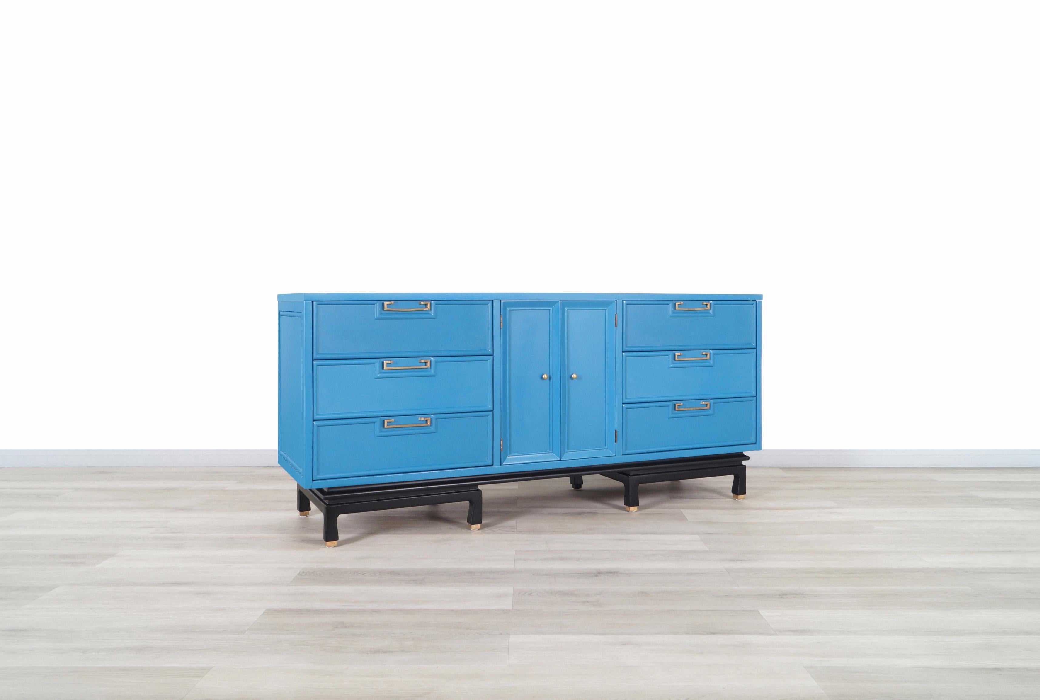 A stunning vintage lacquered dresser designed and manufactured by American of Martinsville in the United States, circa 1950s. This elegant dresser has been professionally restored in Olympic Blue lacquer finish. Features a total of nine dovetailed