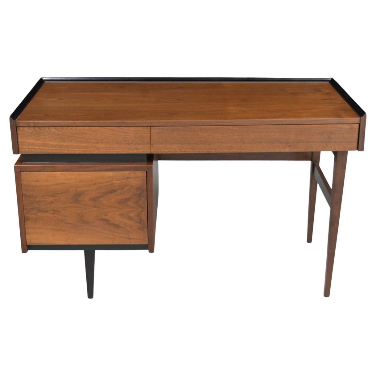 This extraordinary executive danish modern desk is hand-crafted out of walnut wood and is in great condition has been completed restored stripped and newly refinished by our professional craftsmen team in the house. This mid-century vintage desk is