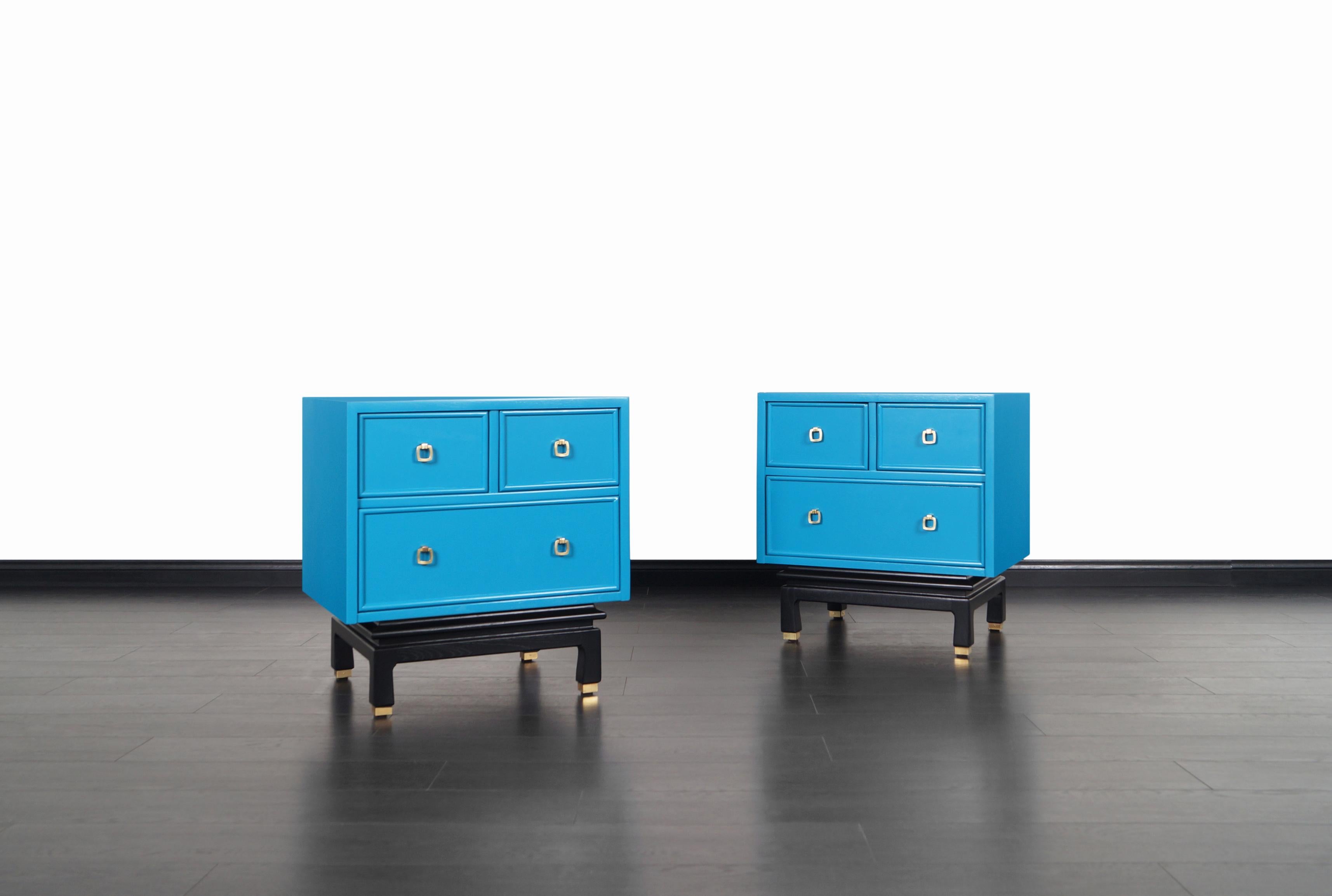 Pair of beautiful lacquered nightstands designed and manufactured by American of Martinsville in the United States, circa 1950s. These lovely nightstands are professionally restored in Olympic blue lacquer finish. Each nightstand features three