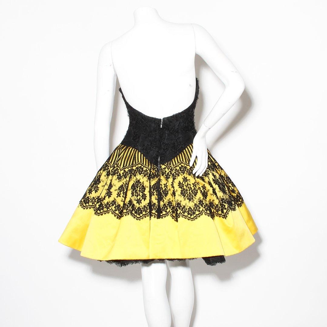 Product Details:
Vintage Haute Couture Pouf Dress by Christian Lacroix 
1980's
Can Can style
Strapless bodice with boning
Ribbon texture detailing
Yellow silk satin skirt 
Black French lace overlay
Back zip and hook and eye closure
Interior