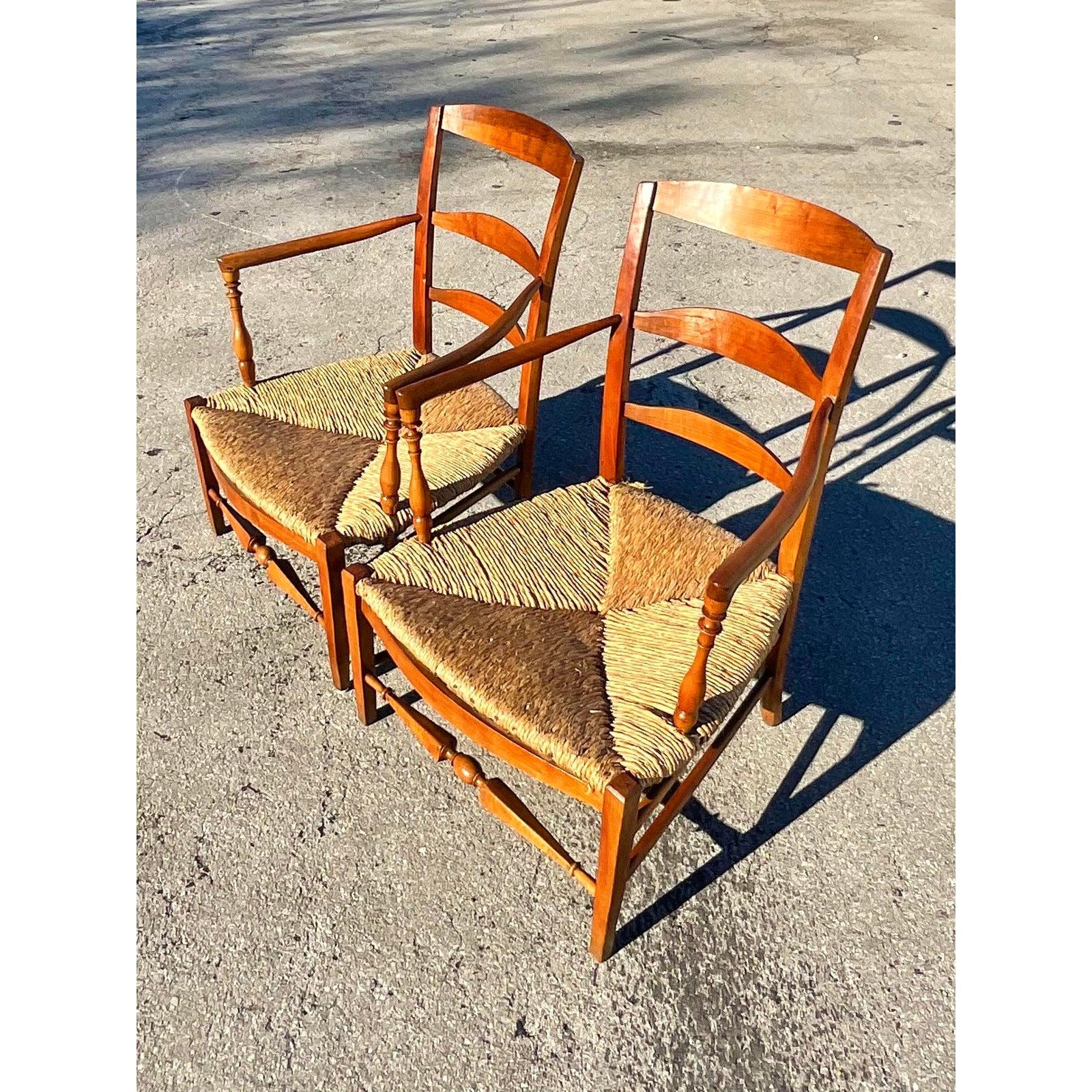 Fantastic pair of vintage ladder back lounge chairs. Chic primitive rush seats with a fabulous set of white cotton duck cushions. Lots of cool details like wider rush cord and exposed nail heads in the seats. Acquired from a Philadelphia estate.