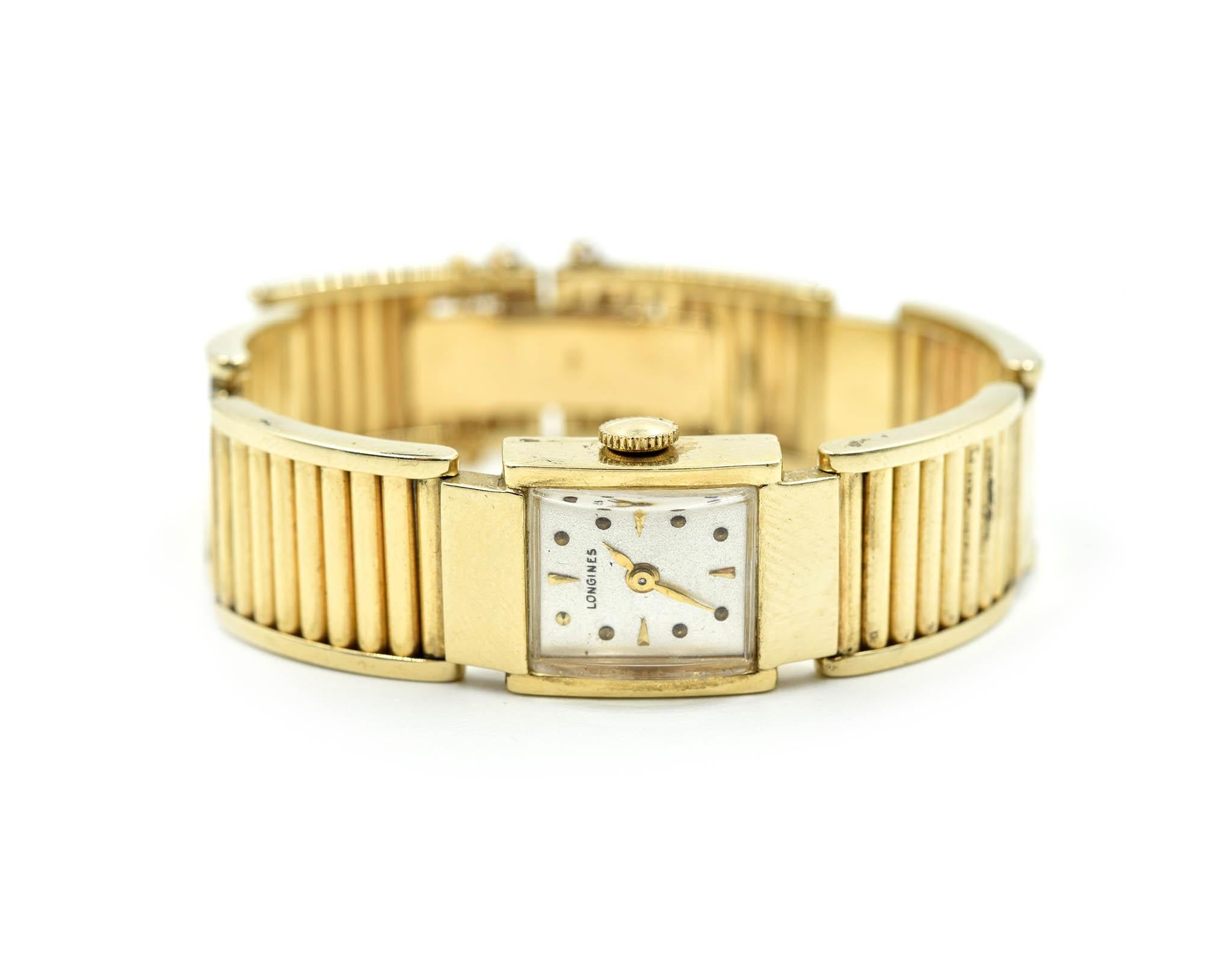 Movement: manual wind
Function: hours, minutes
Case: 14mm x 23mm rectangular 14k yellow gold case, domed plastic crystal, pull/push crown
Dial: silver dial with gold dot hour markers and arrow hour markers quarterly, gold hands
Band: solid 14k