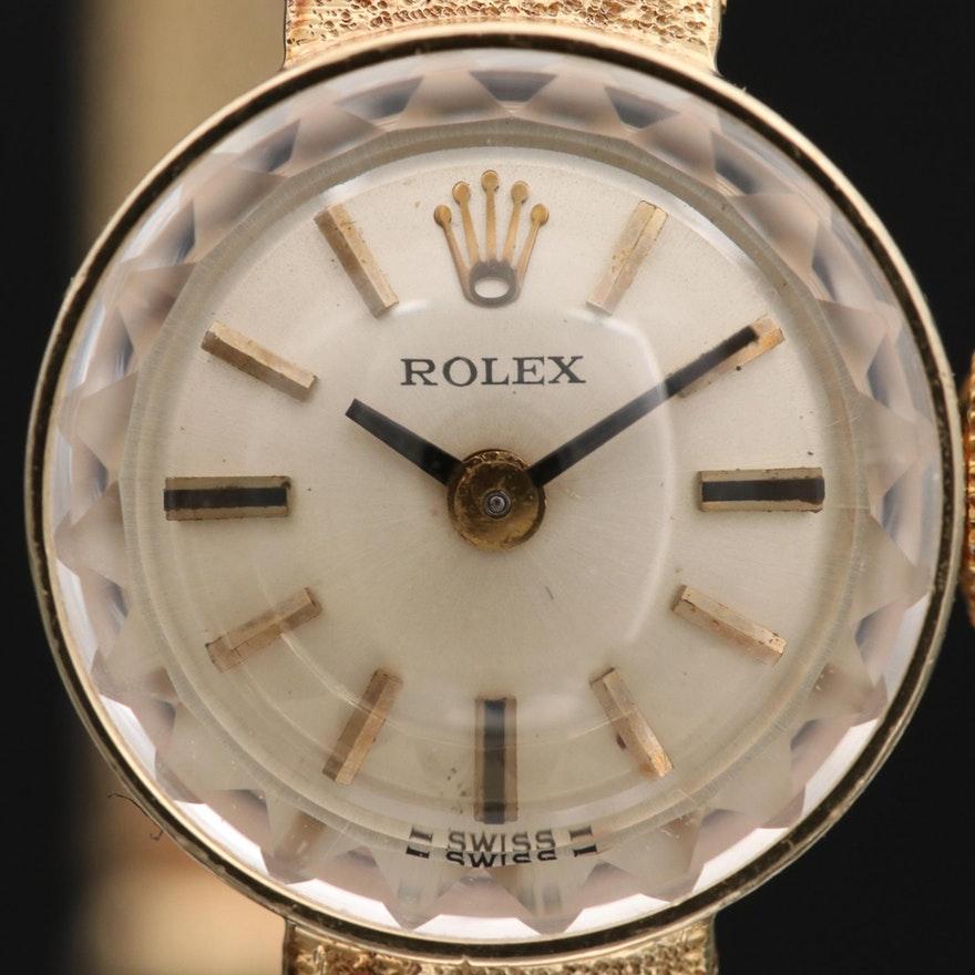 Item Details
A circa mid-1980’s 14K gold Rolex Cocktail wristwatch. A luxury watch with a sleek design that features a beautiful faceted crystal above a silvered dial with gold index hour markers and baton-style hands. This elegant watch is
