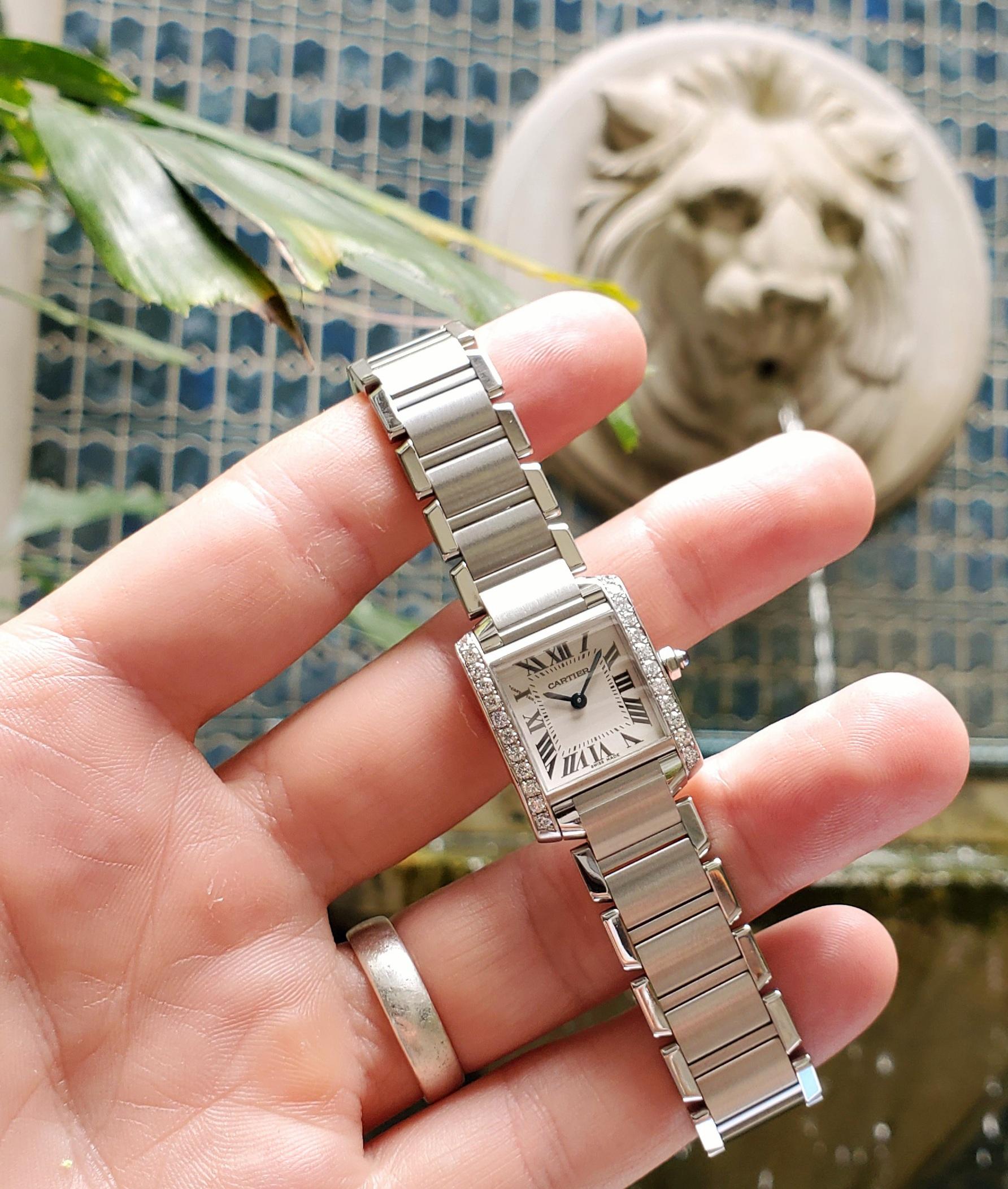 Vintage Stainless Steel Cartier Tank Francaise timepiece, small case size. This beautiful timepiece has diamonds added to the bezel surround. Classic Cartier, this sleek and elegant timepiece transitions from jeans and your favorite tee, to a