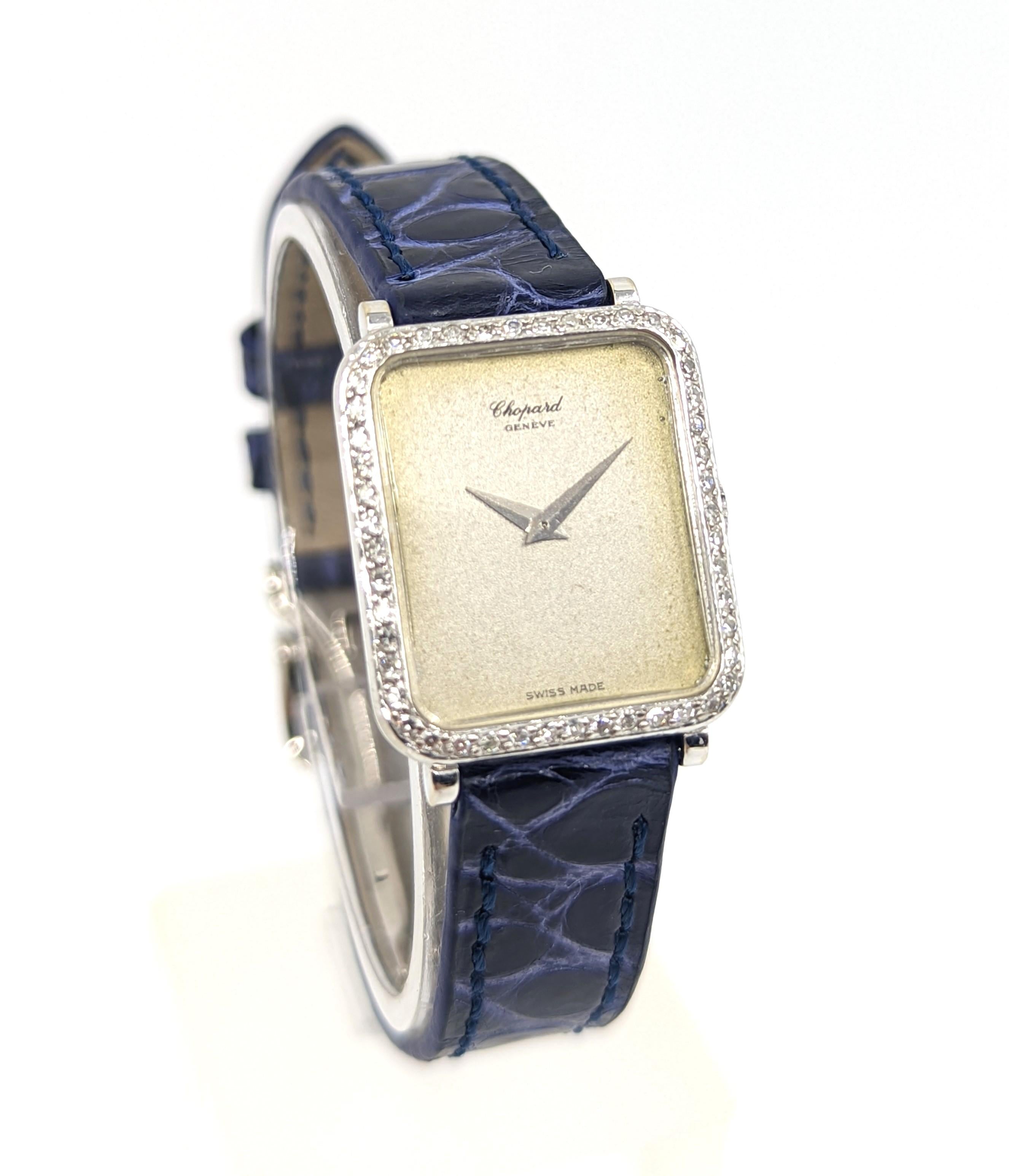 A beautiful vintage Chopard 18K solid white gold wristwatch (reference 8/6495), with a full factory diamond bezel on a blue croco leather band, and factory paired with a Jaeger LeCoultre JLC 18K white gold deployment clasp. Comes with original sales