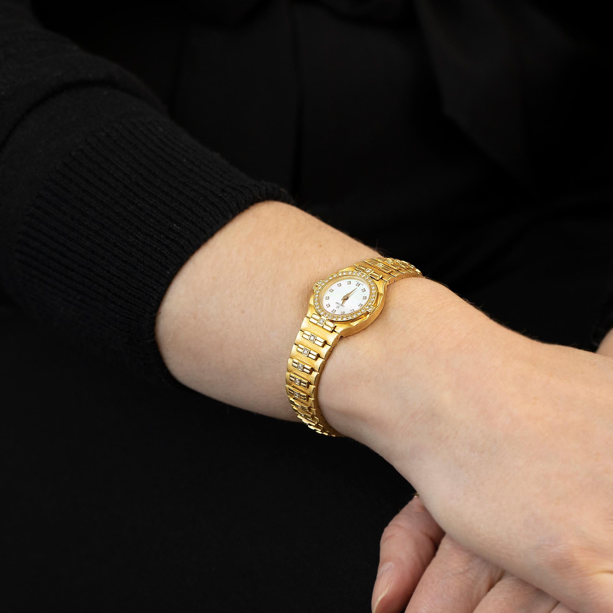 One diamond set ladies Concord brand wristwatch with a matching bracelet in 18k gold. The watch has a Swiss quartz movement, a mother-of-pearl dial, and gold hands with diamond set markers. The bracelet clasp has adjustable sizing 15cm to 16cm