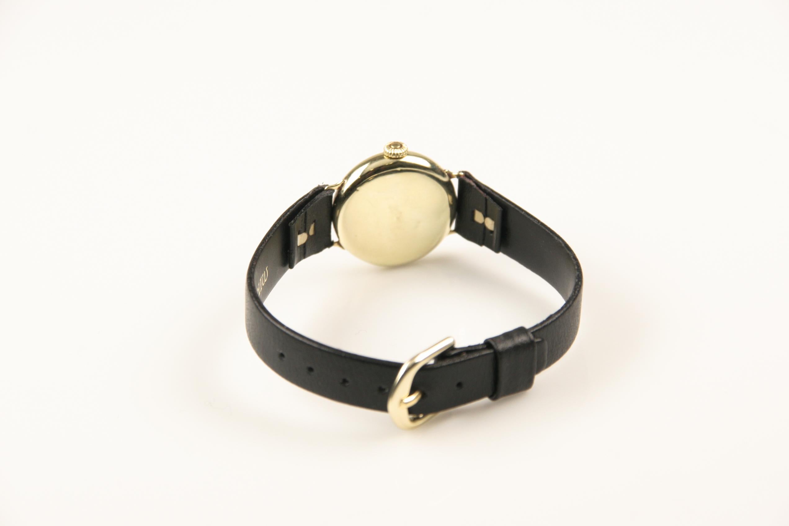 14k yellow gold case.
NOTE: Reverse of case has some dents.
23 mm in diameter (25 mm with crown).
Lug-to-lug distance: 26 mm.
Thickness: 6 mm.

Gold dial with black Art Deco Arabic numerals.
Labeled 