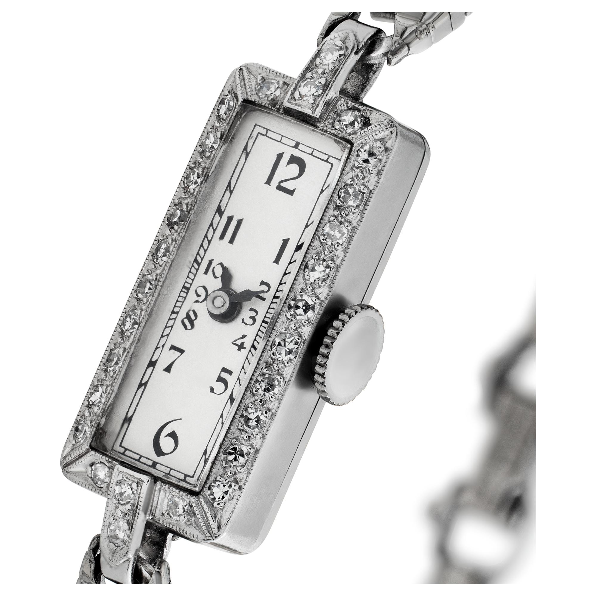 Vintage ladies Elgin in platinum with approx. 0.20 carats in G-H color, VS clarity  diamond bezel and gold-filled bracelet. Manual. With security chain on the clasp. Circa 1930s. Fine Pre-owned Elgin Watch. Certified preowned Vintage Elgin watch is