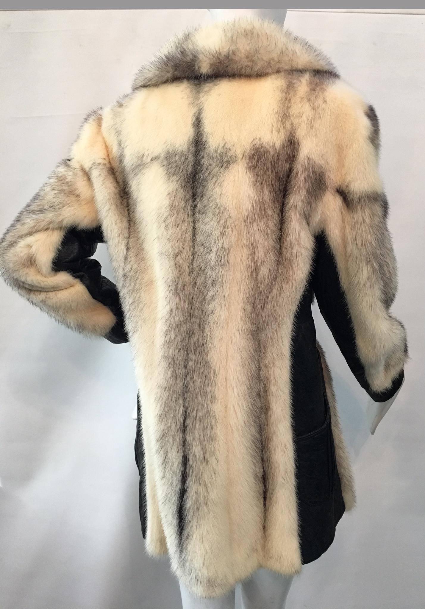 Vintage 1980s fur and leather coat by Juan de Cirota features large fur collar and integrated leather belt.  Excellent vintage condition with only the most minor signs of gentle use.  No size marking.
Approx. measurements:
Bust: 18