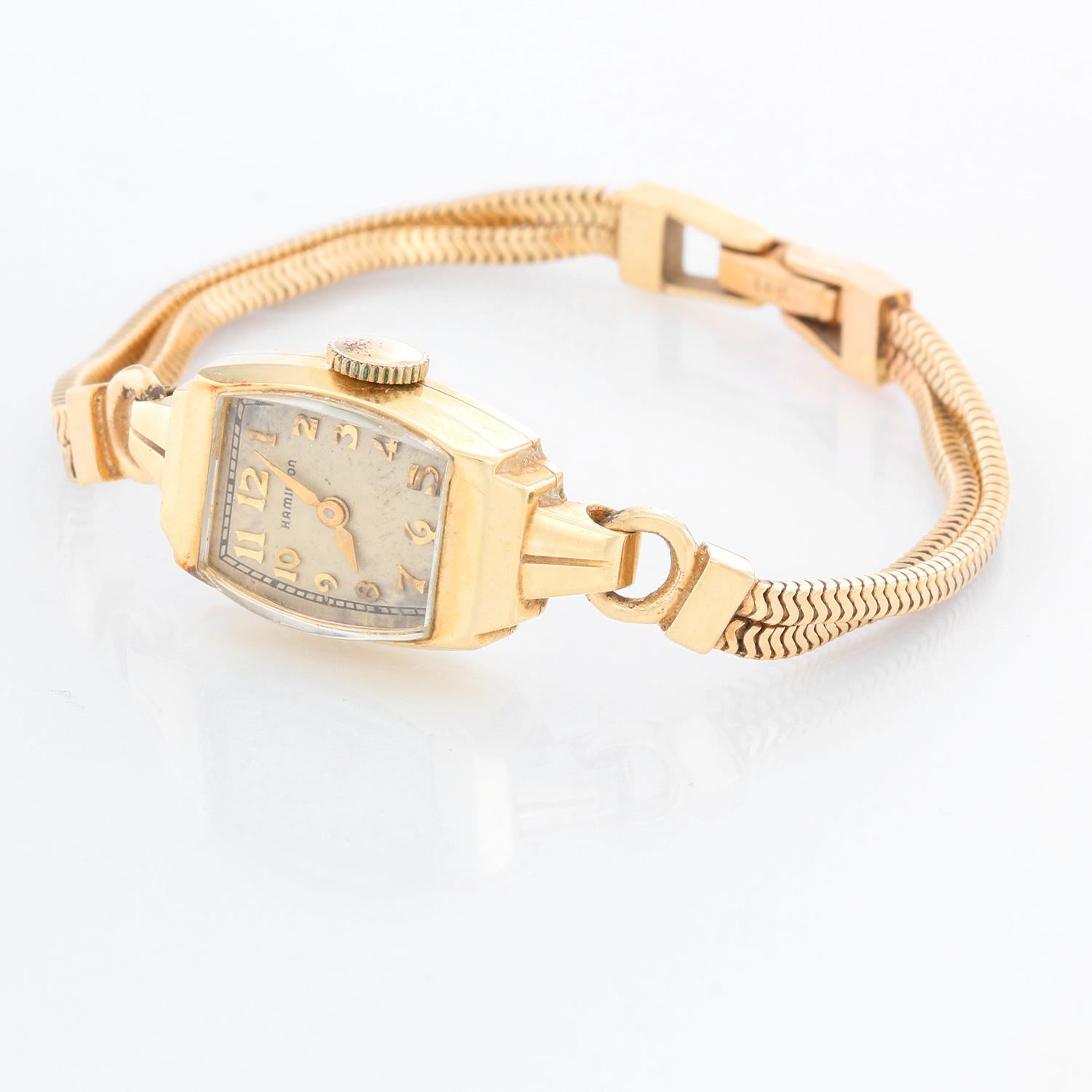 Vintage Ladies Hamilton 14K Yellow Gold  Watch - Manual winding. 14K yellow gold case  (14mm x 29mm). Ivory colored dial with Arabic numerals. 14K yellow gold double rope bracelet. ( will fit a 5 3/4 inch wrist). Pre-owned with custom box.