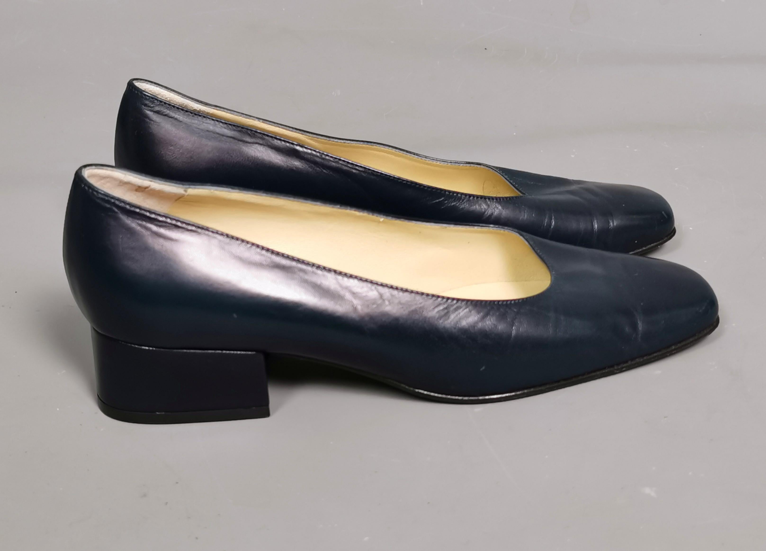 A classic and versatile pair of vintage ladies navy blue leather court shoes.

They are a dark navy blue with a low / mid block heel and a slightly squared toe.

Labelled inside and to the sole for Bally.

They are a marked as a ladies UK size 4.5