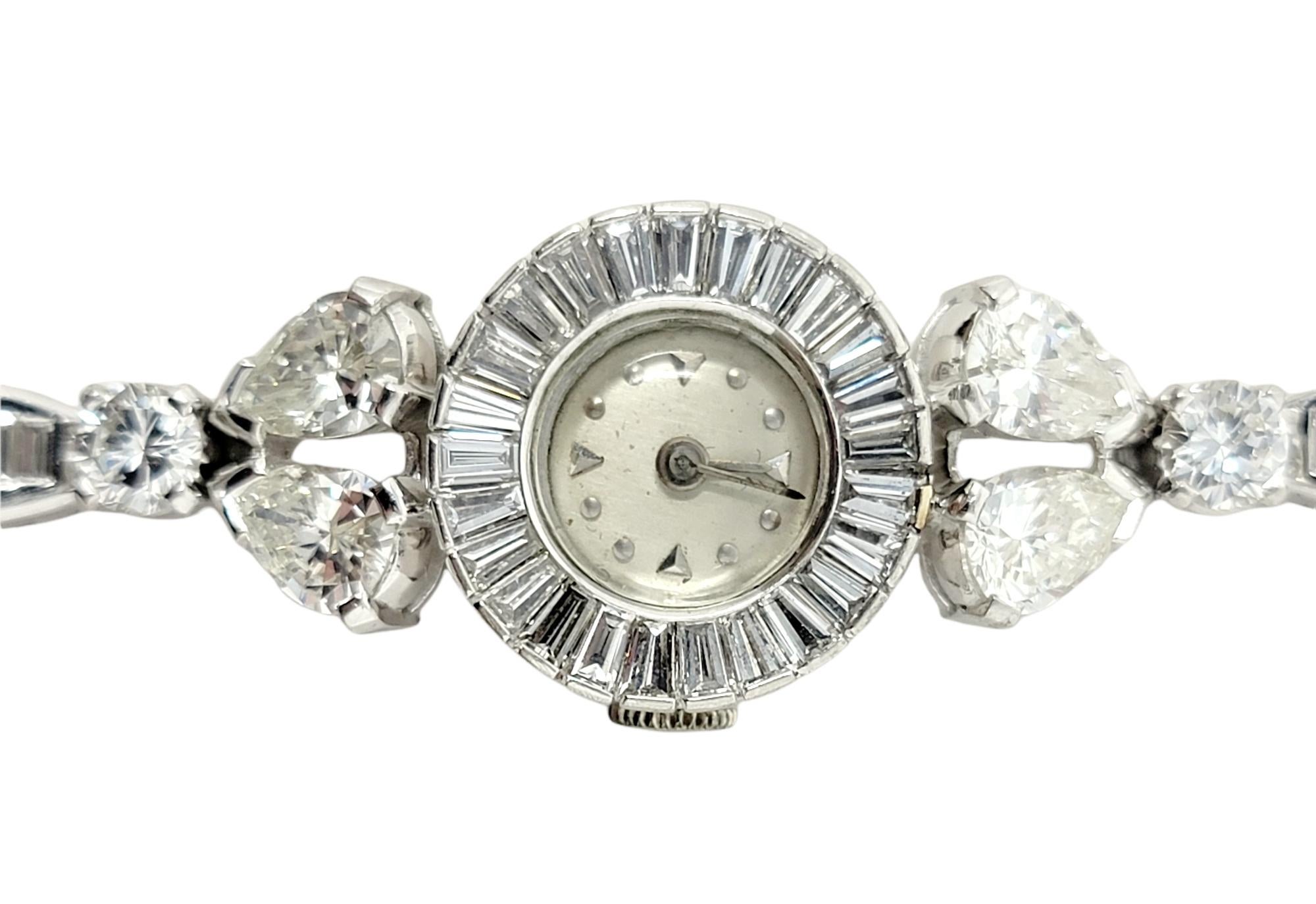 Exquisite vintage wristwatch embellished with 9.23 carats of glittering natural diamonds. Featuring flexible, elongated platinum links, the glittering bracelet gently wraps the wrist, showcasing the 84 sparkling diamonds that shimmer and shine from