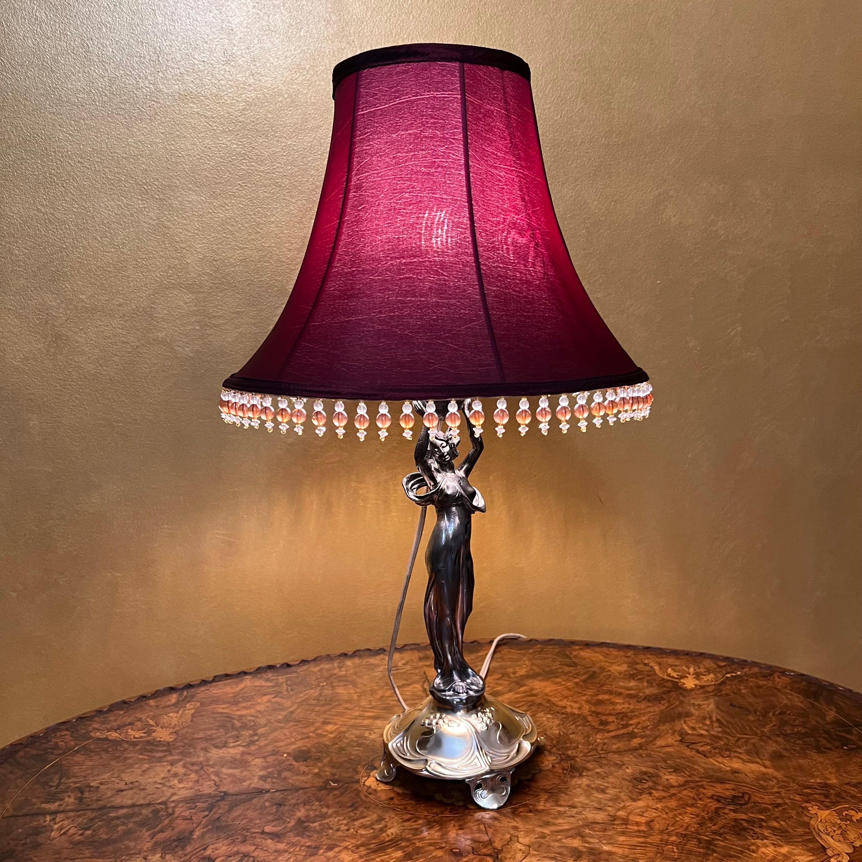 Lady shape lamp body silver body, brass base, burgundy lamp shape.

Material: Brass

Measurements: 59cm high, 17cm diameter 

Pick Up Location at: 64 Kalang Road, Edensor Park NSW

Postage via Australia Post with tracking available