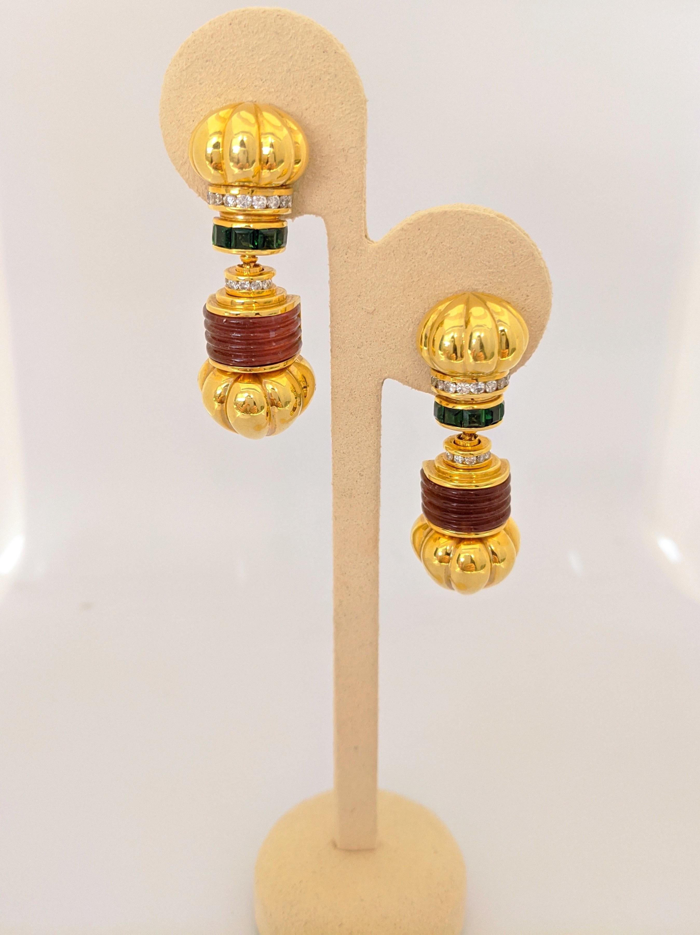  Designed by Lagos from their signature Caviar collection. These earrings feature their Iconic fluted drop hearts along with carved ribbed Pink Tourmaline and square cut Chrome Tourmaline. Two rows of round brilliant Diamonds accent these 18 karat
